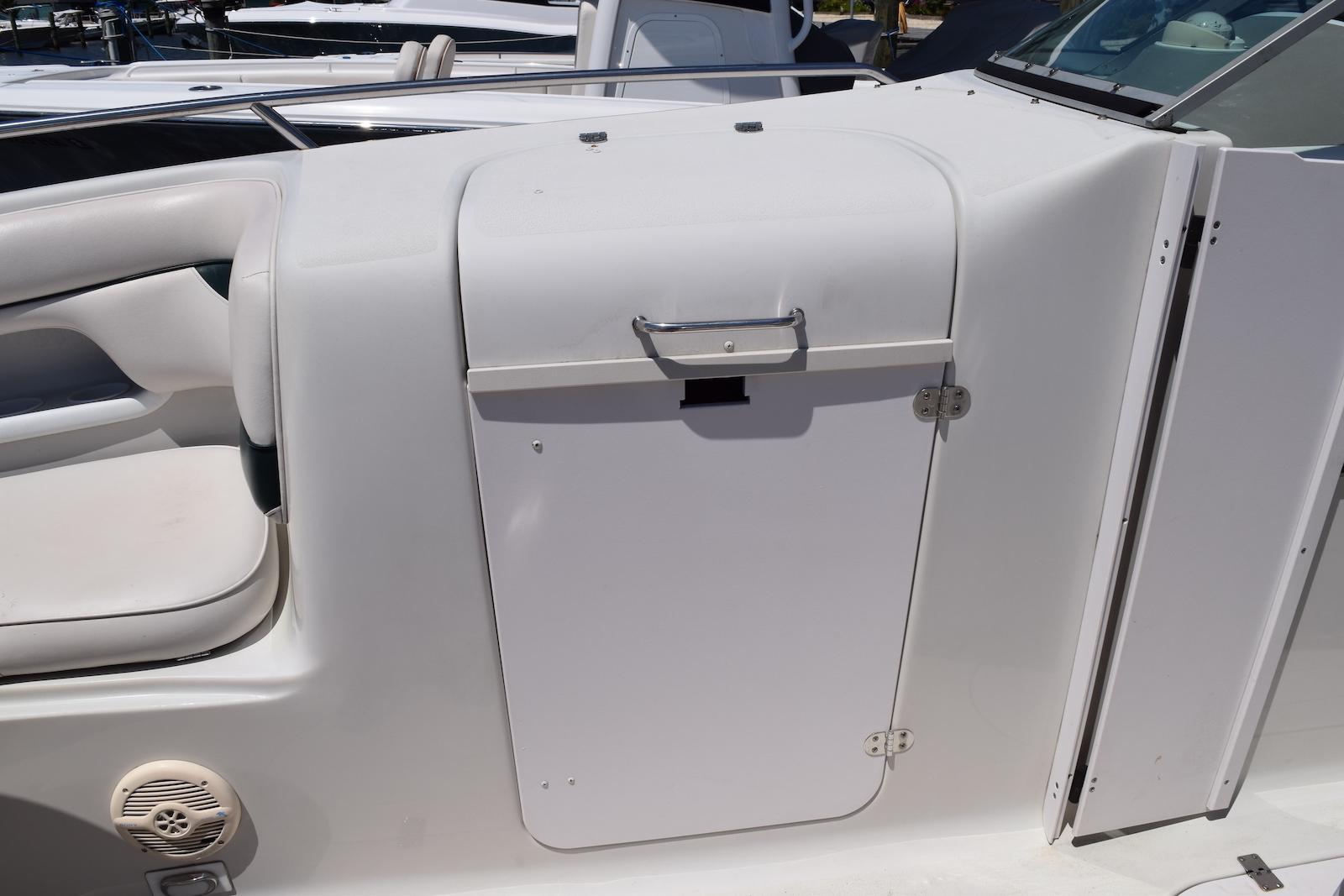 2001 Crownline 288 BR boat interior with white seating and storage compartment.