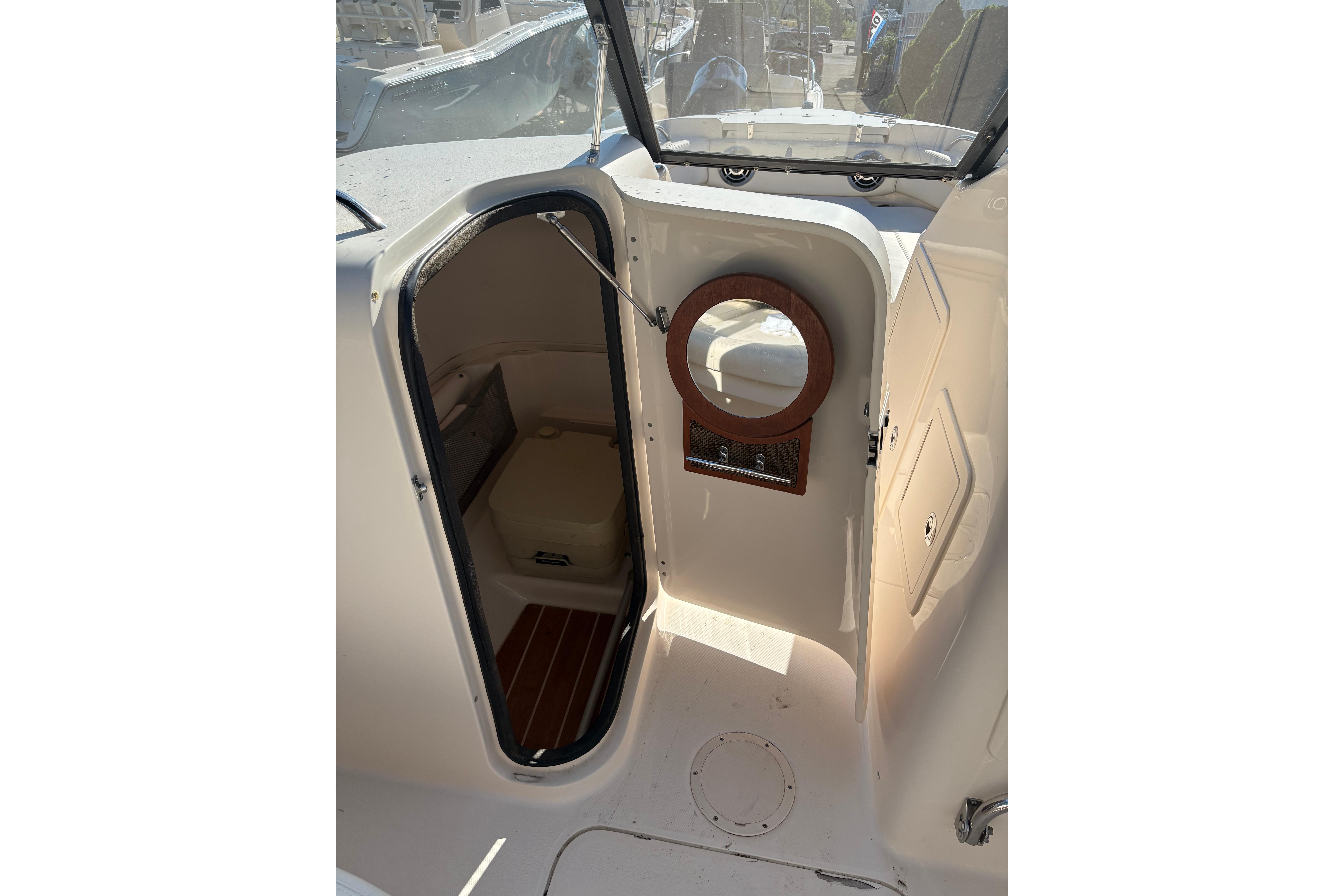 2015 Grady-White Freedom 225 boat cabin interior with open door and porthole.