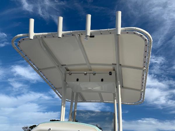2024 Robalo R202 Explorer boat T-top against blue sky.