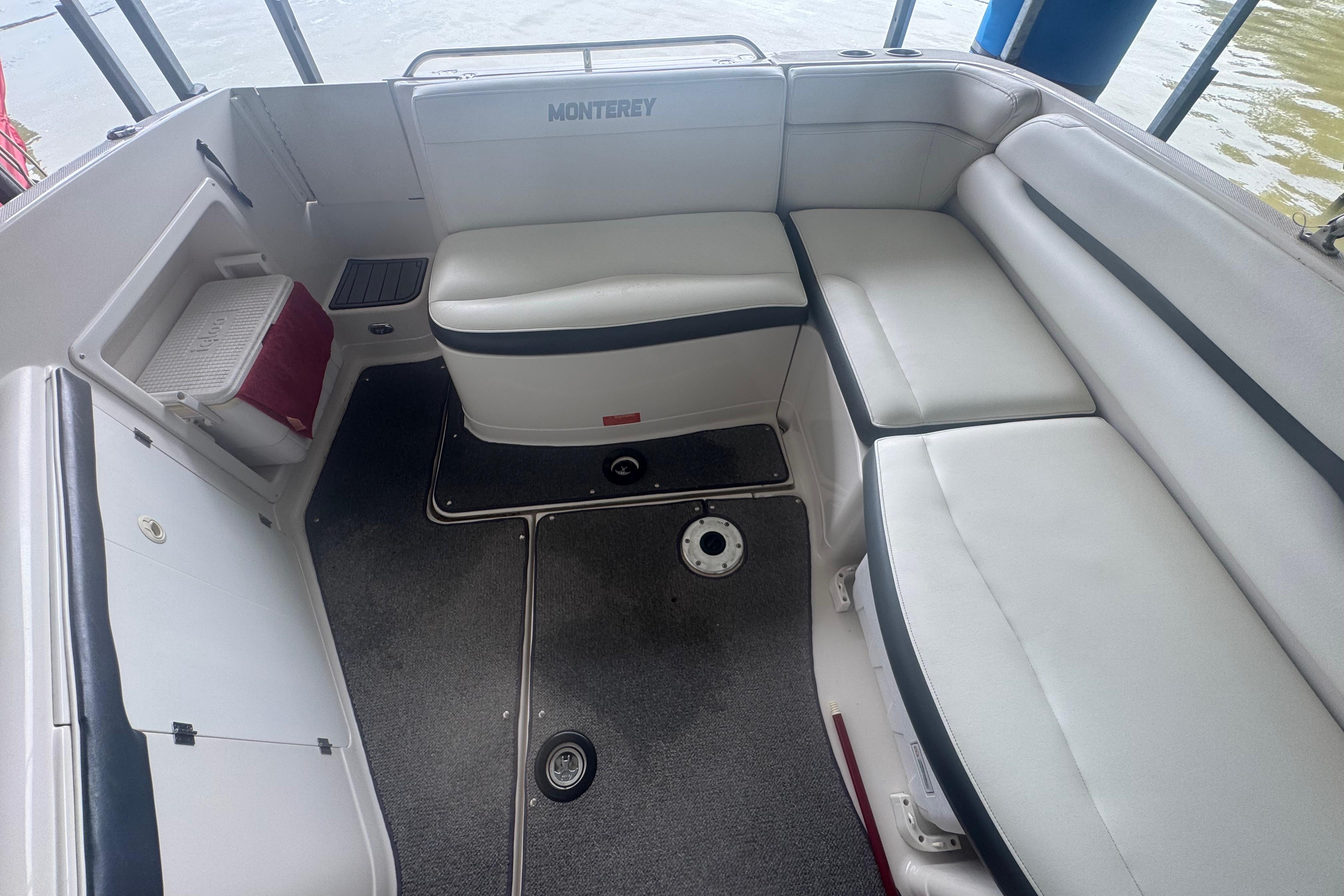 2005 Monterey 248LS Montura Bowrider interior with white seating and storage compartments.