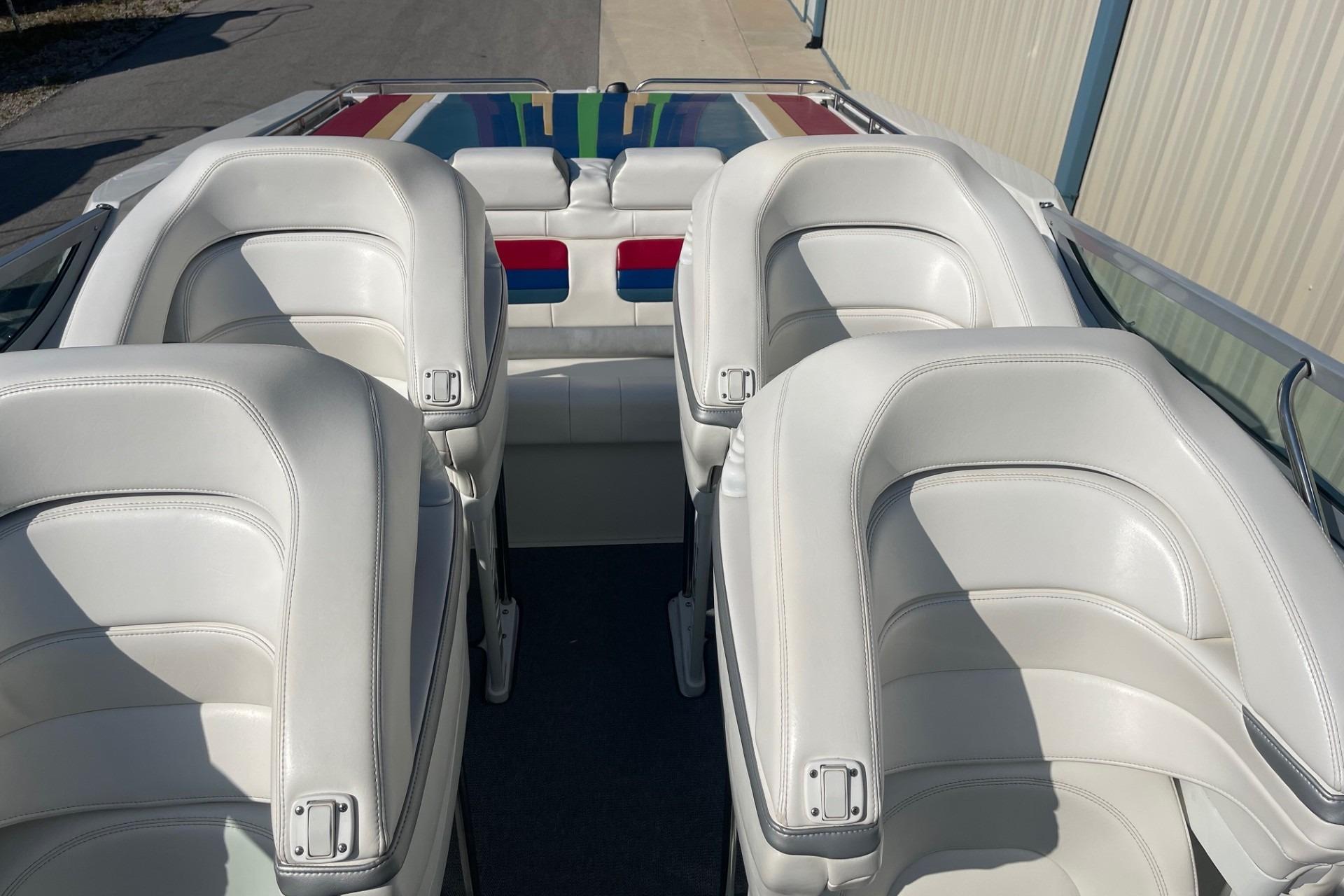 2004 Formula 382 FASTech boat interior with white leather seats and colorful accents.