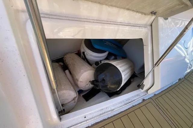 Storage compartment on a 2016 Sea Ray Sundancer 510 yacht with boating equipment.