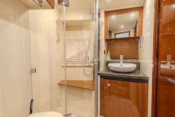 Luxurious bathroom in 2016 Sea Ray Sundancer 510 yacht with modern fixtures and wood accents.