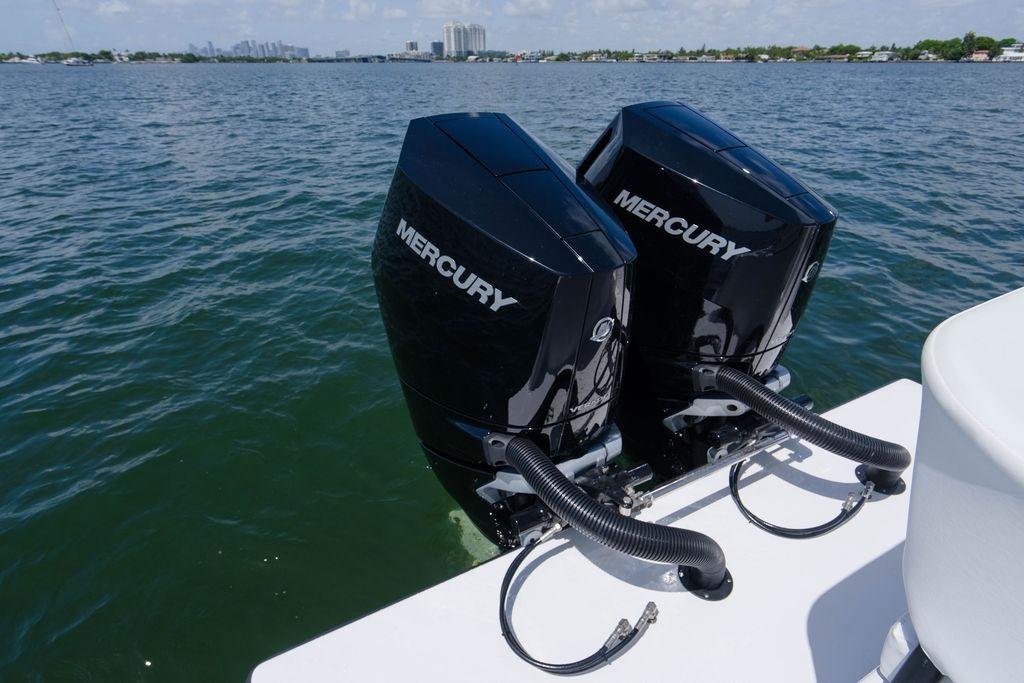 Twin Mercury outboard engines on a 2027 Reef Runner 340 boat, cruising on open water.