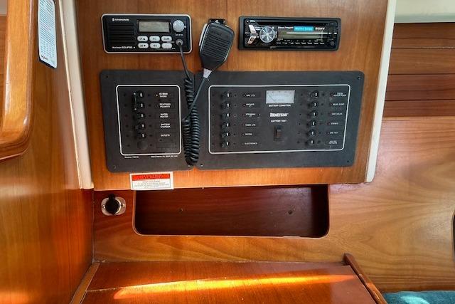Control panel of a 2000 Beneteau Oceanis 321 sailboat with radio and switches.