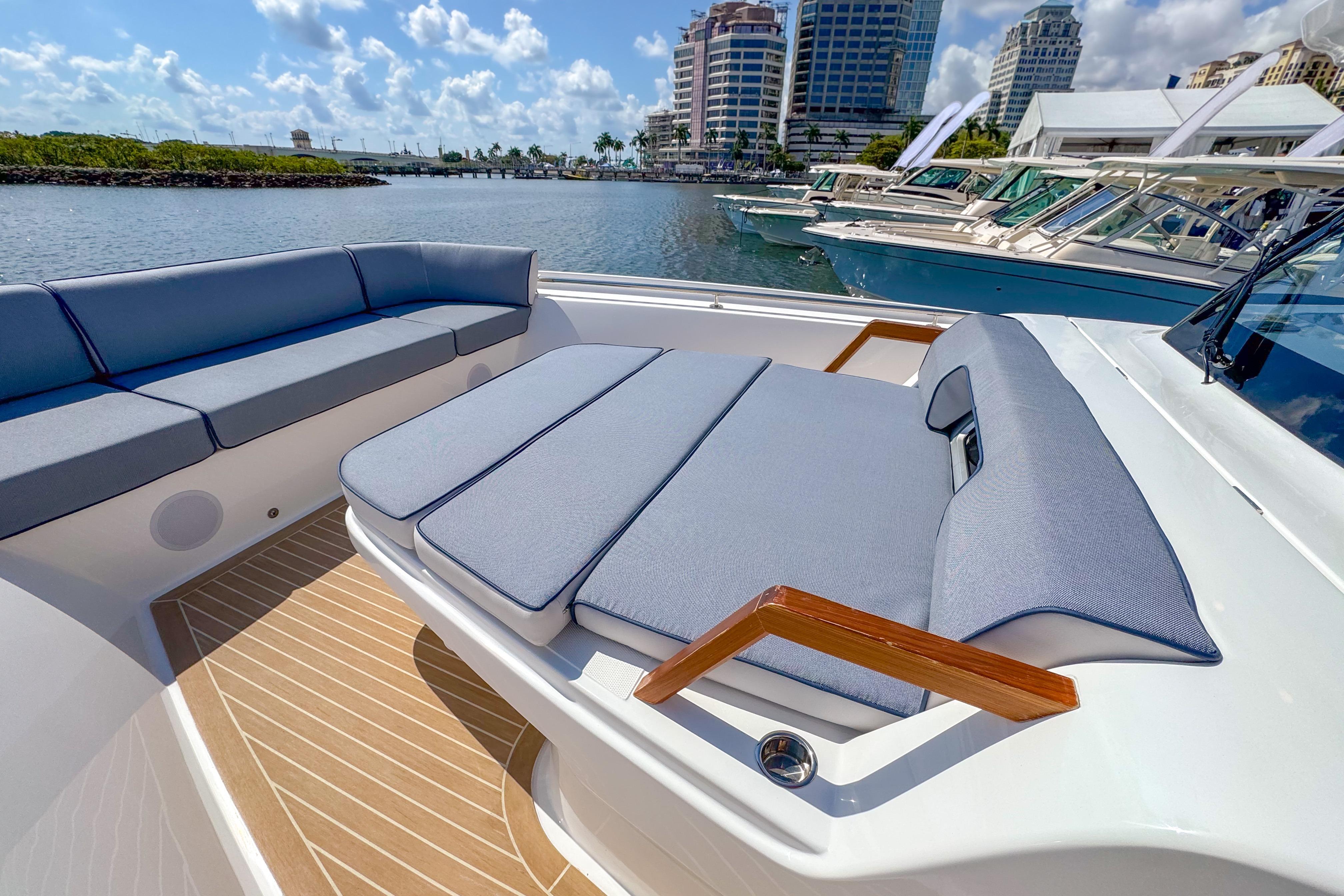 Luxurious seating on 2025 Aiata Wayfinder 38 Cabin yacht, docked in a marina.