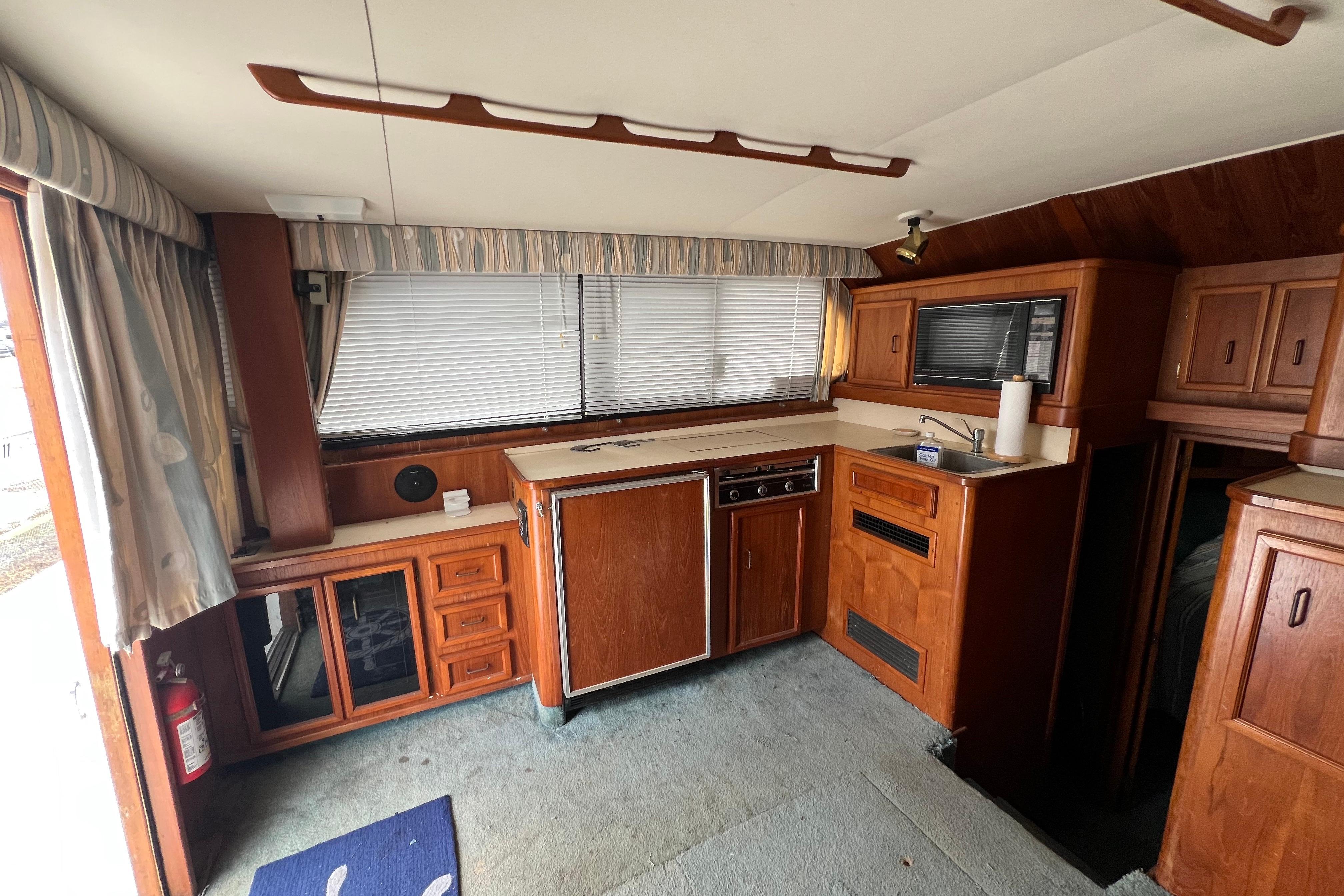 Interior of a 1989 Egg Harbor 35 Sport Fisherman with wood cabinetry and compact kitchen.