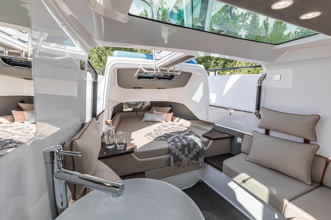 Luxurious interior of 2023 Axopar 37 XC Cross Cabin with wet bar and seating.