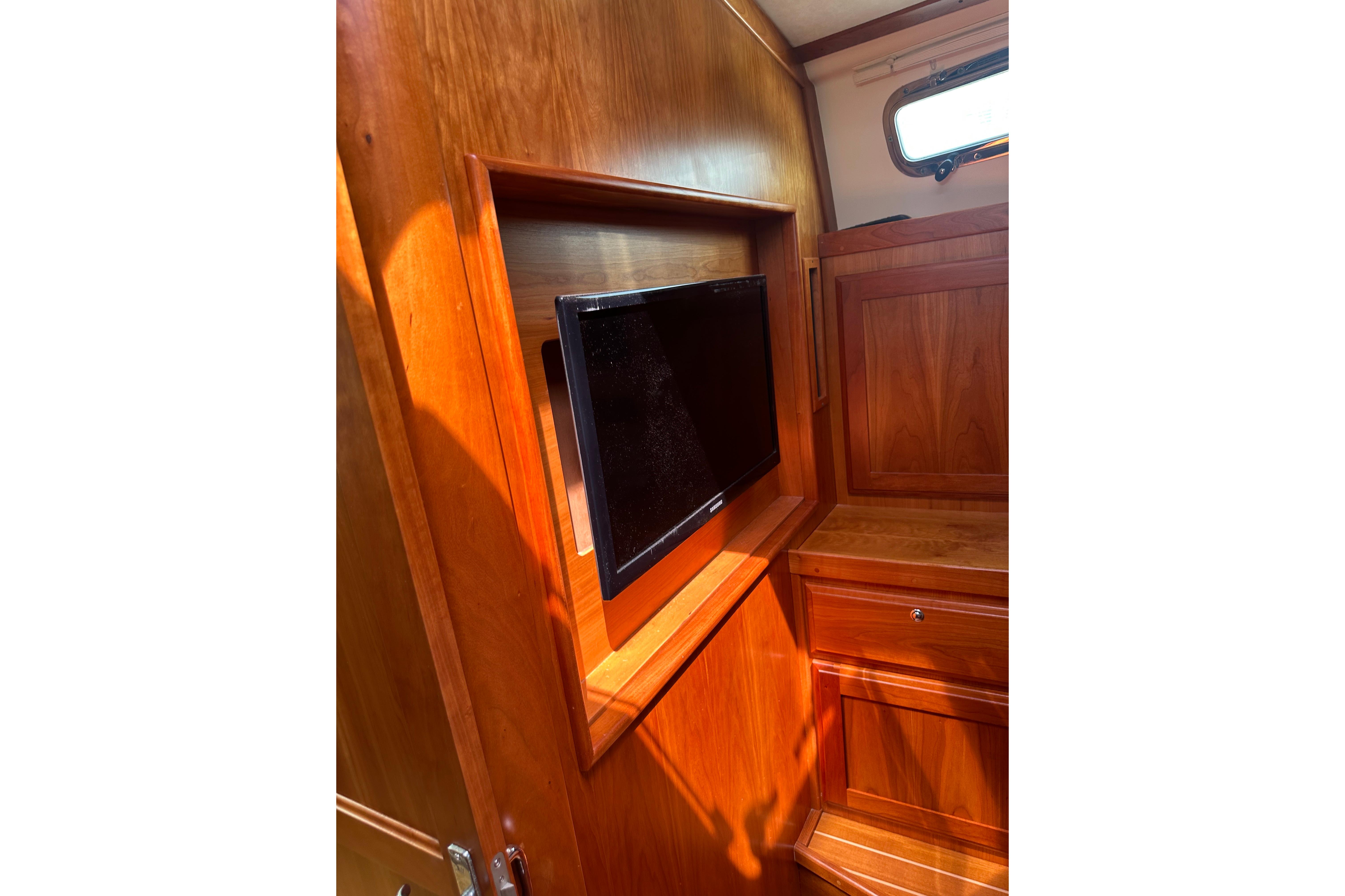 Interior of 2013 Sabre 38 Salon Express with built-in TV and wooden cabinetry.