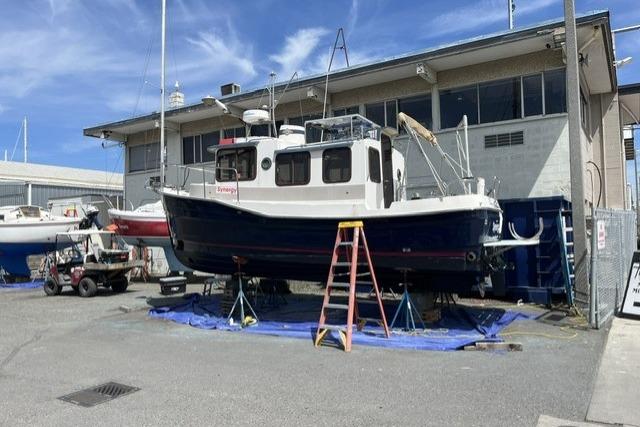 2008 Ranger 25 on stands at a marina, clear sky background.