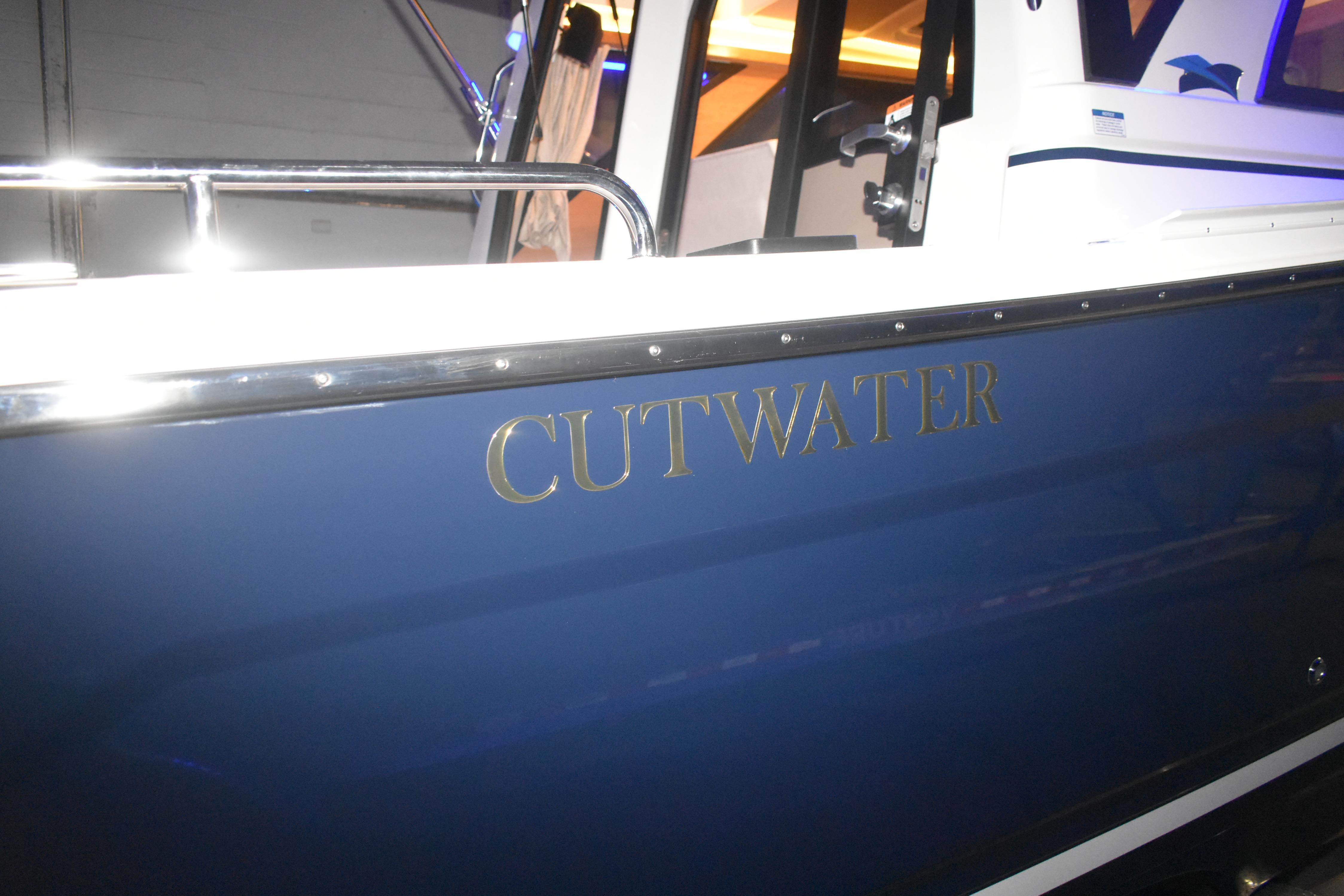 2026 Cutwater C-248 Coupe boat with blue hull and chrome lettering.