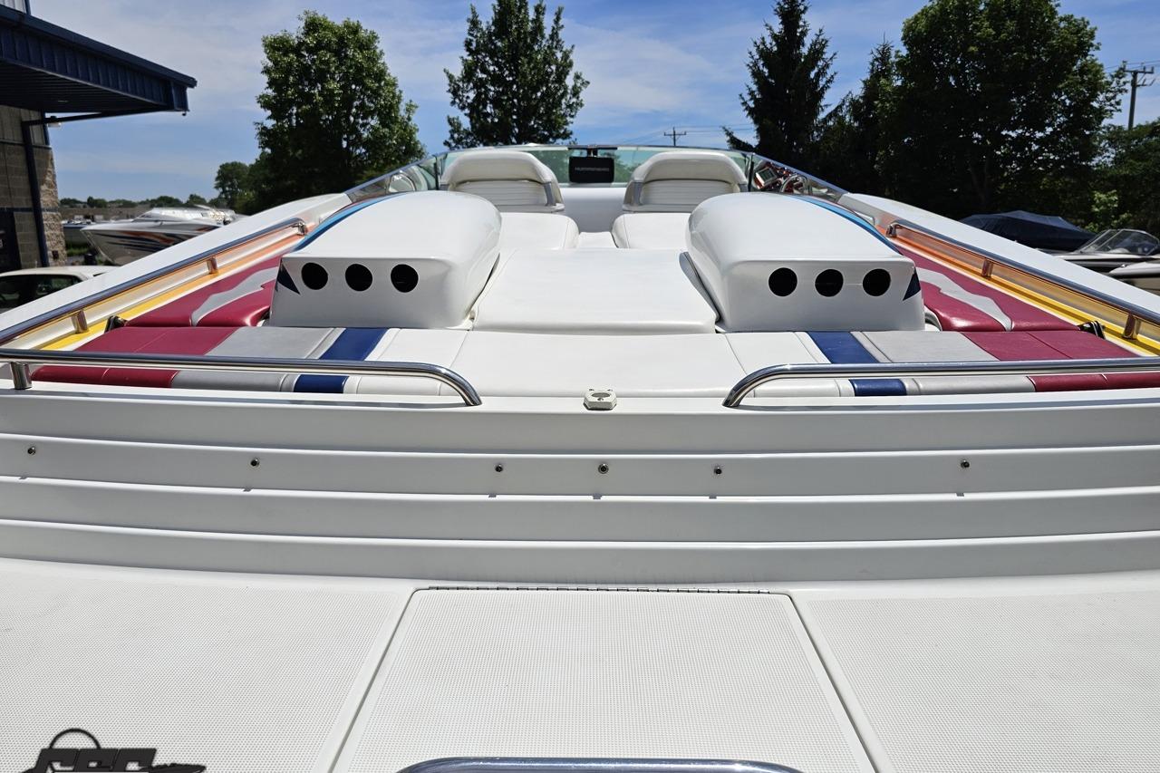 2002 Formula 382 FASTech boat with colorful seating and sleek design, docked outdoors.