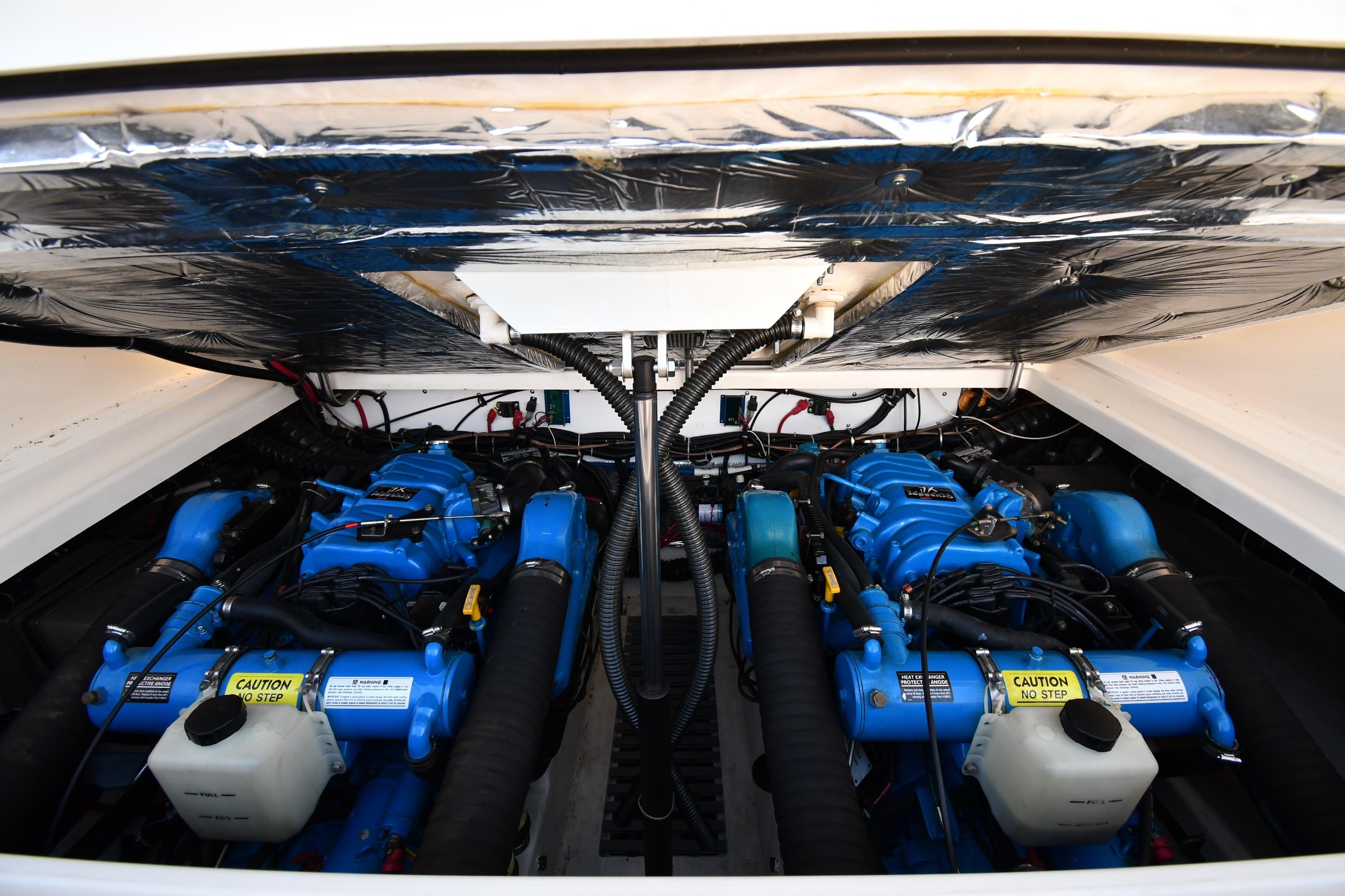 Engine compartment of a 1998 Tiara Yachts 3100 Open, featuring dual blue engines.