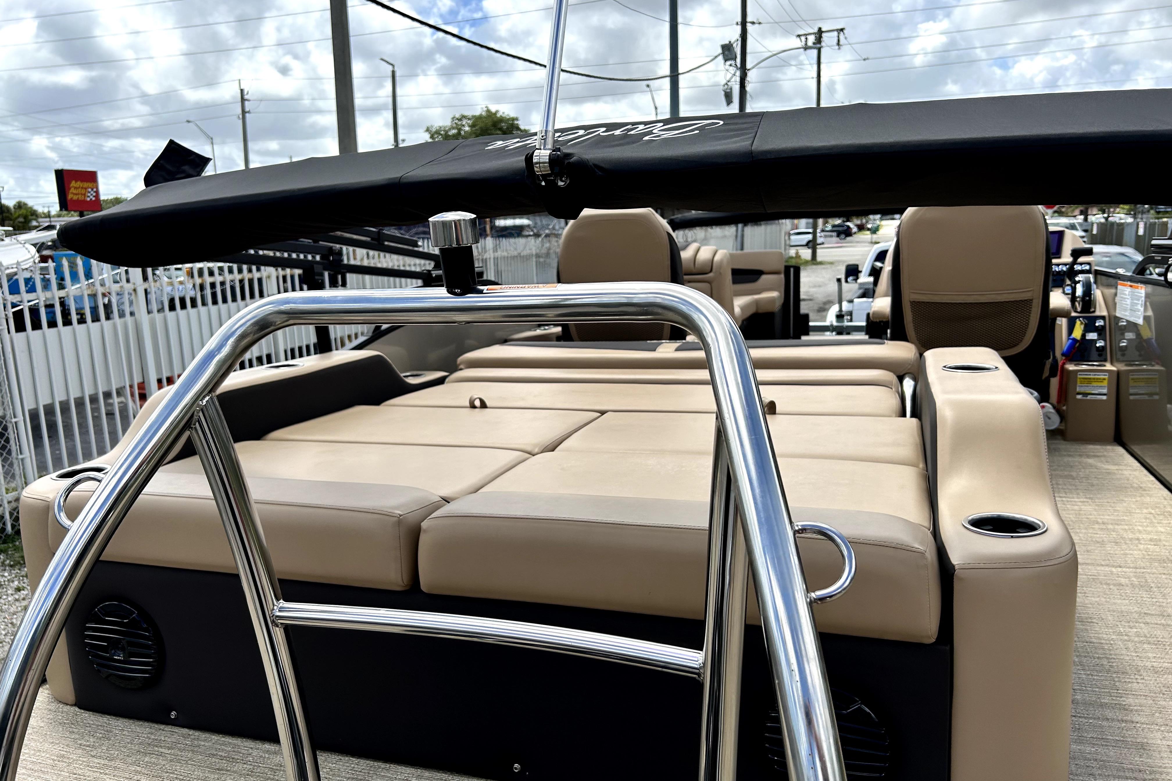 2022 Barletta E24UC pontoon boat with beige seating and sleek design.