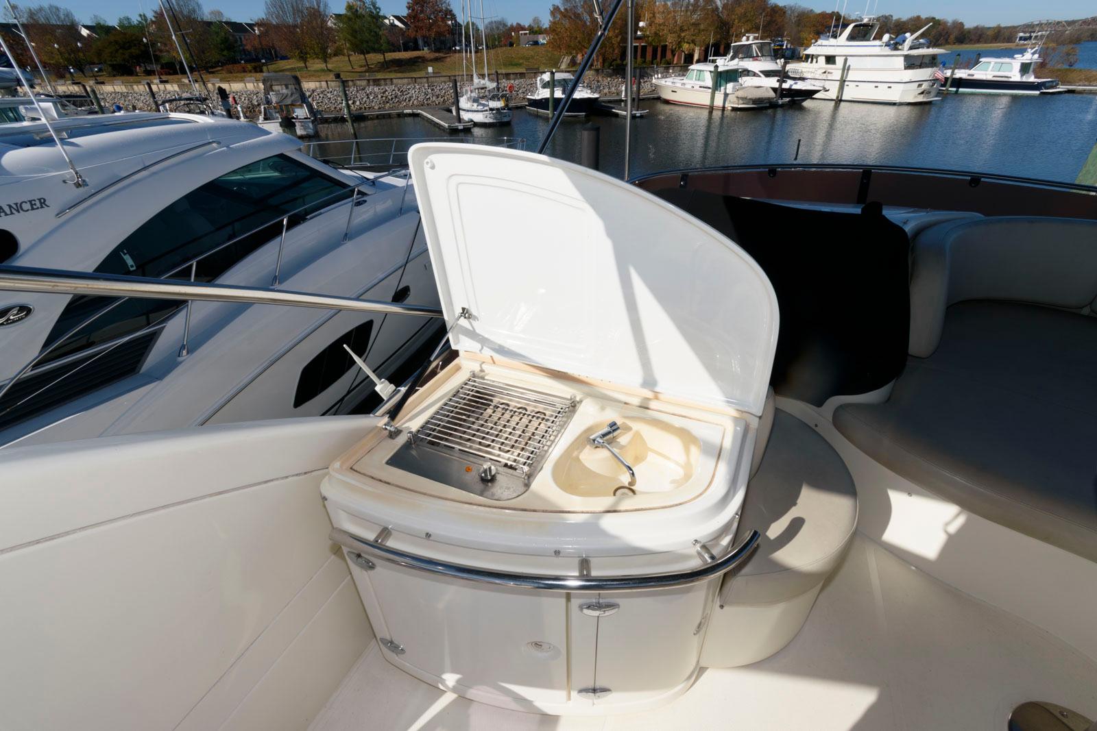 Azimut 50 Flybridge 2005 yacht with open grill and sink on deck.