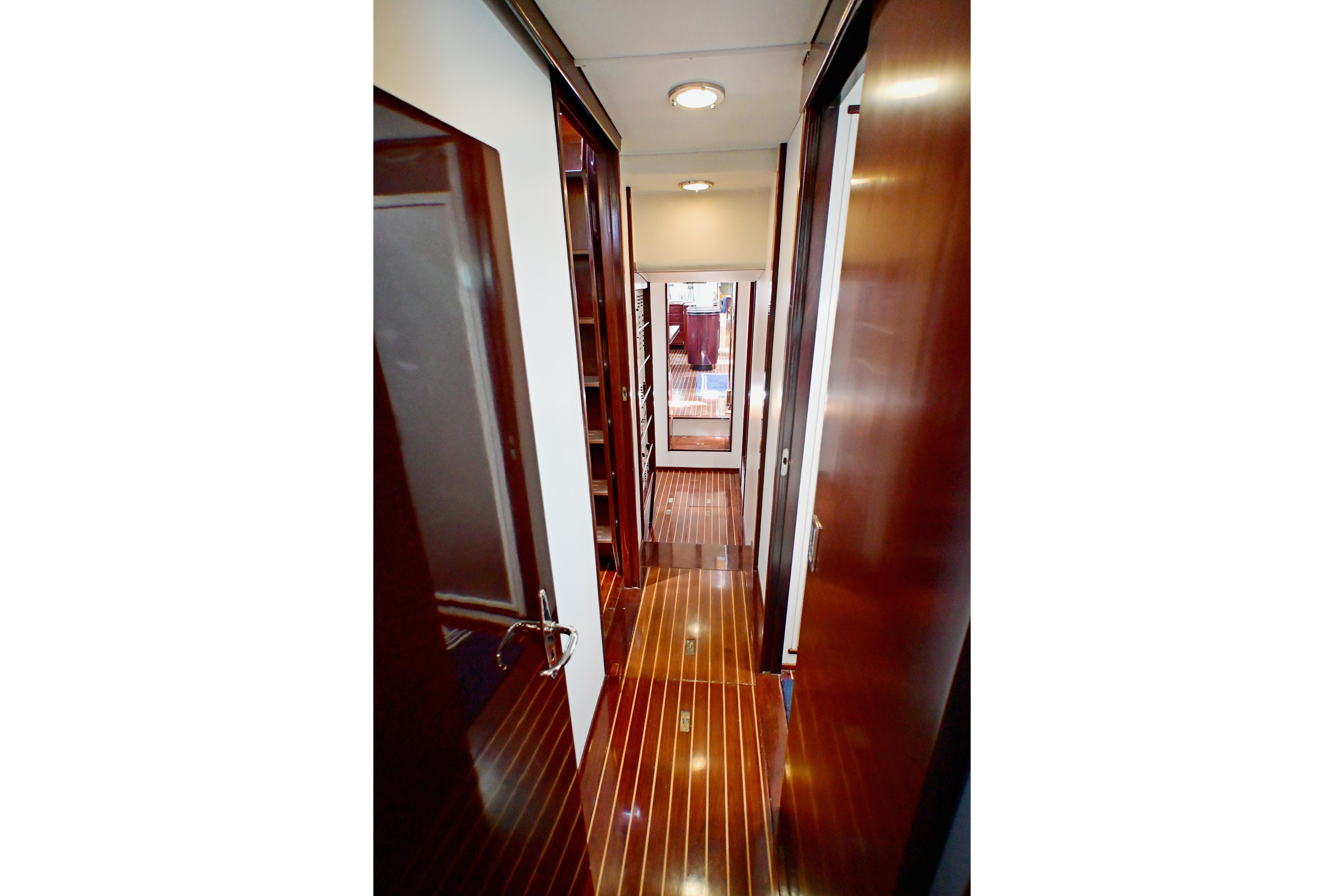 Narrow wooden hallway inside a 1968 Abeking & Rasmussen Tripp 74 yacht.