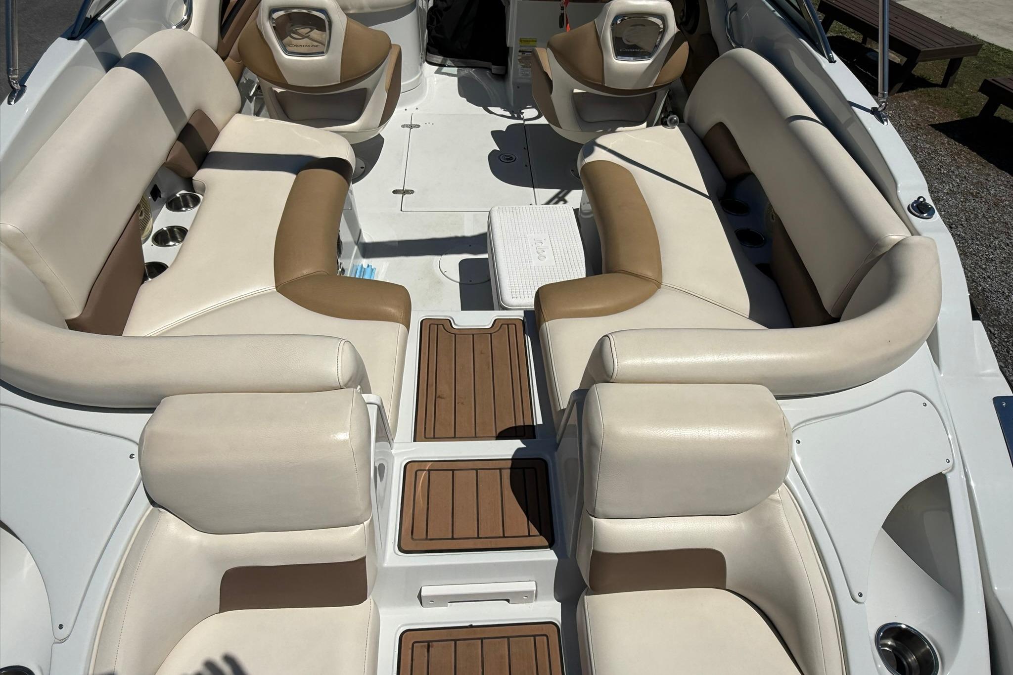 2016 Crownline 255 SS boat interior with beige and brown seating, wood-style flooring.