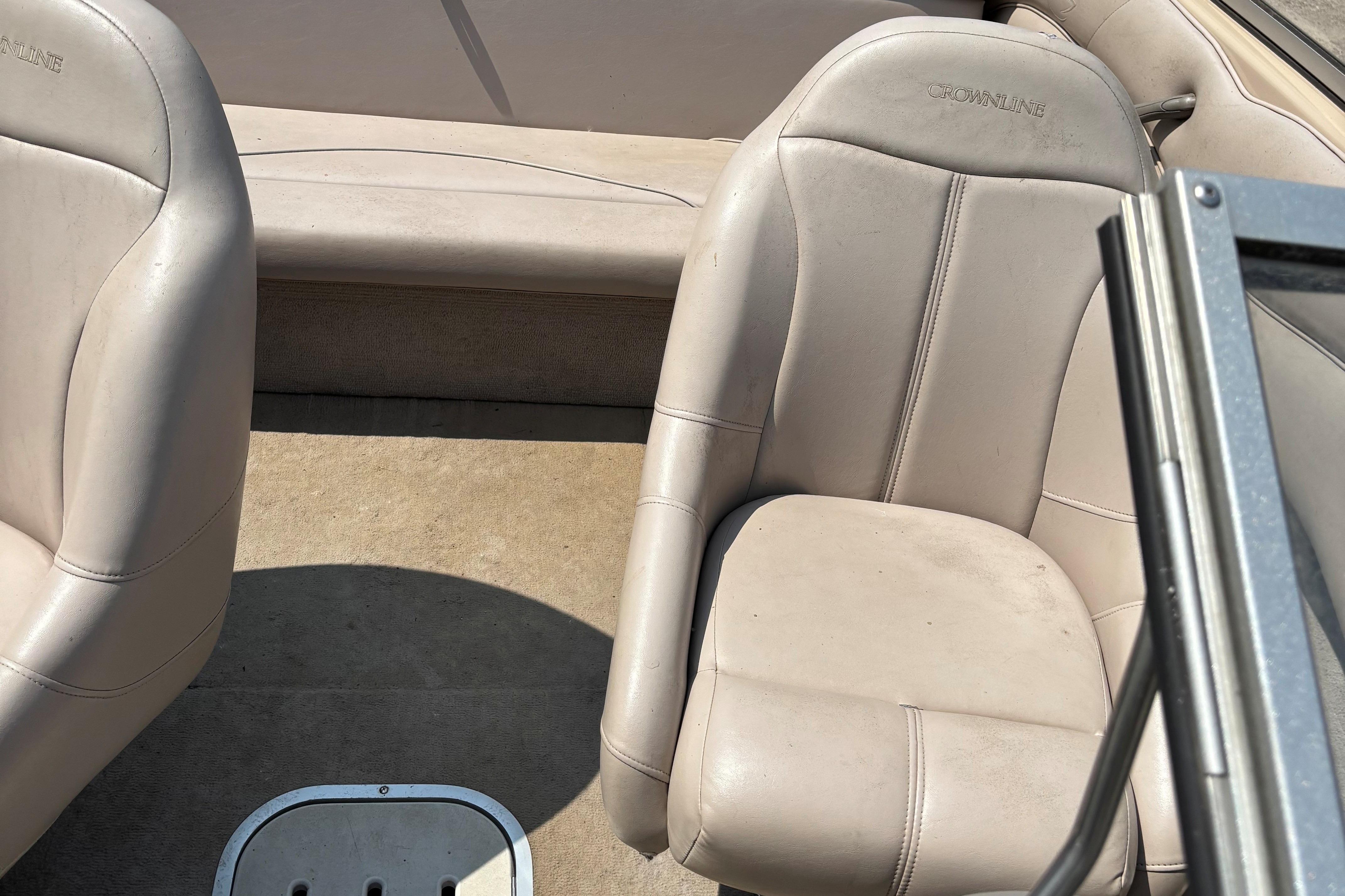 Interior of a 2001 Crownline 18' boat with beige seating.