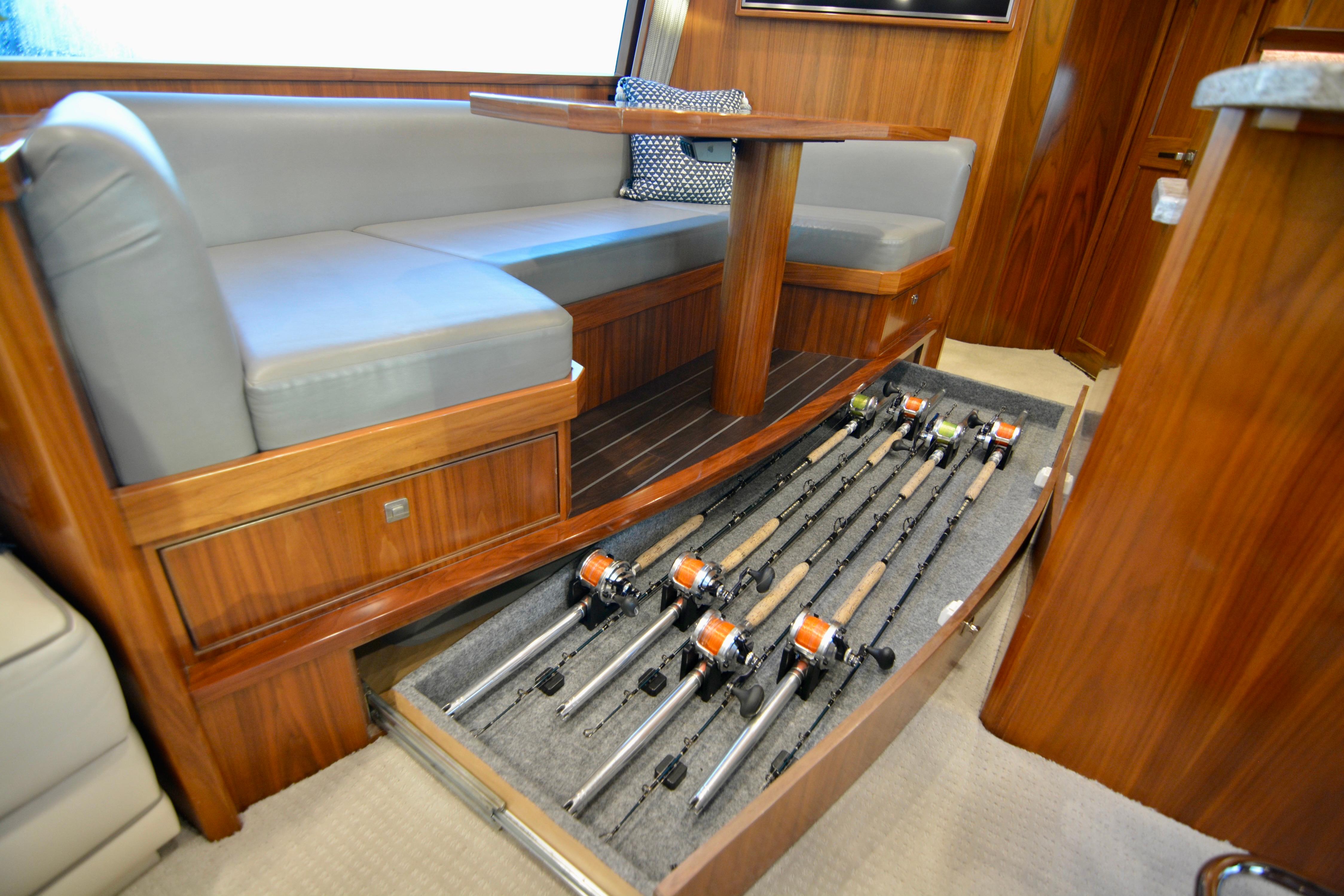 2019 Viking 68 Convertible yacht interior with fishing rod storage under seating.