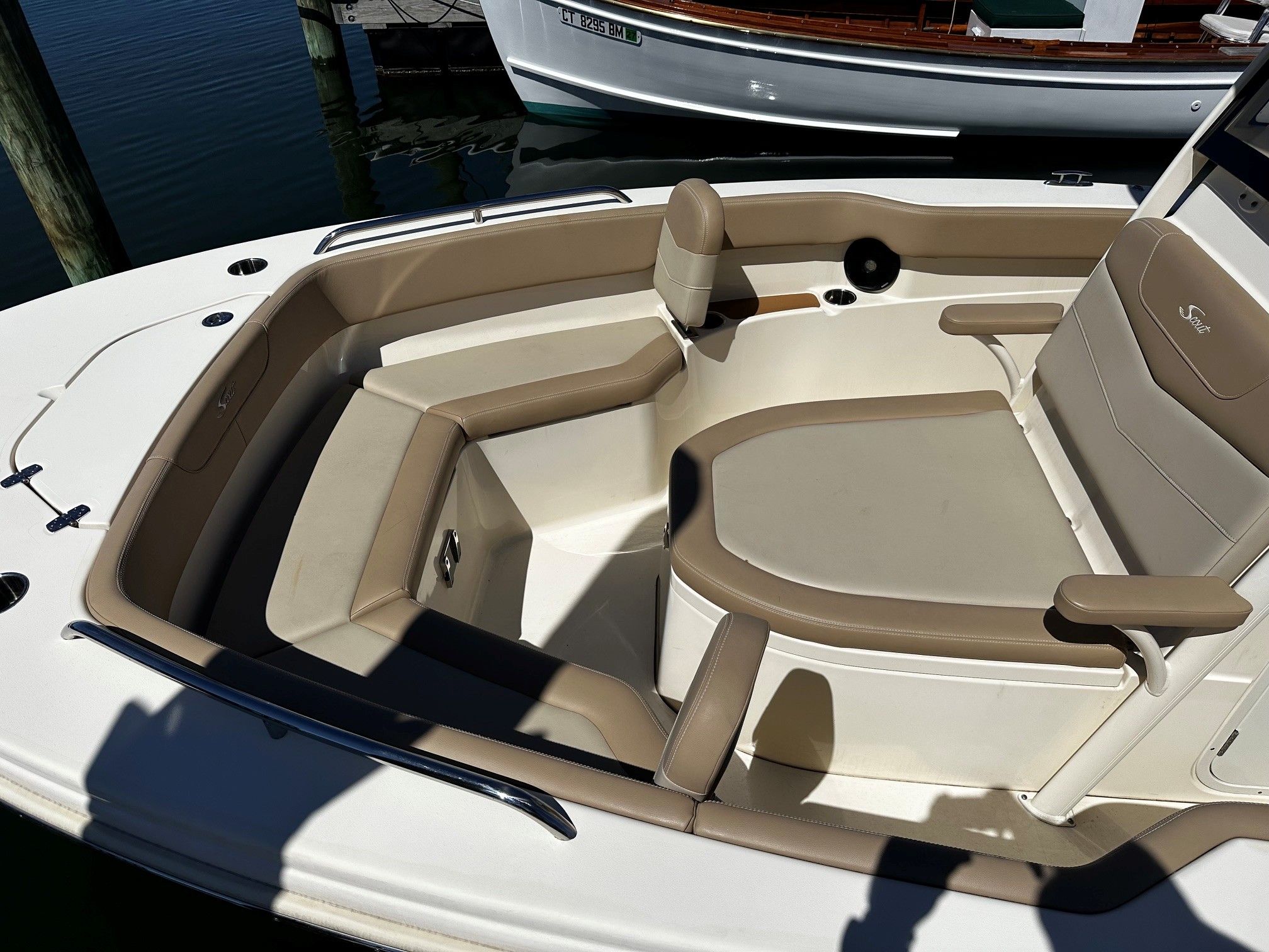 Scout 210XSF 2022 boat with beige interior at dock.