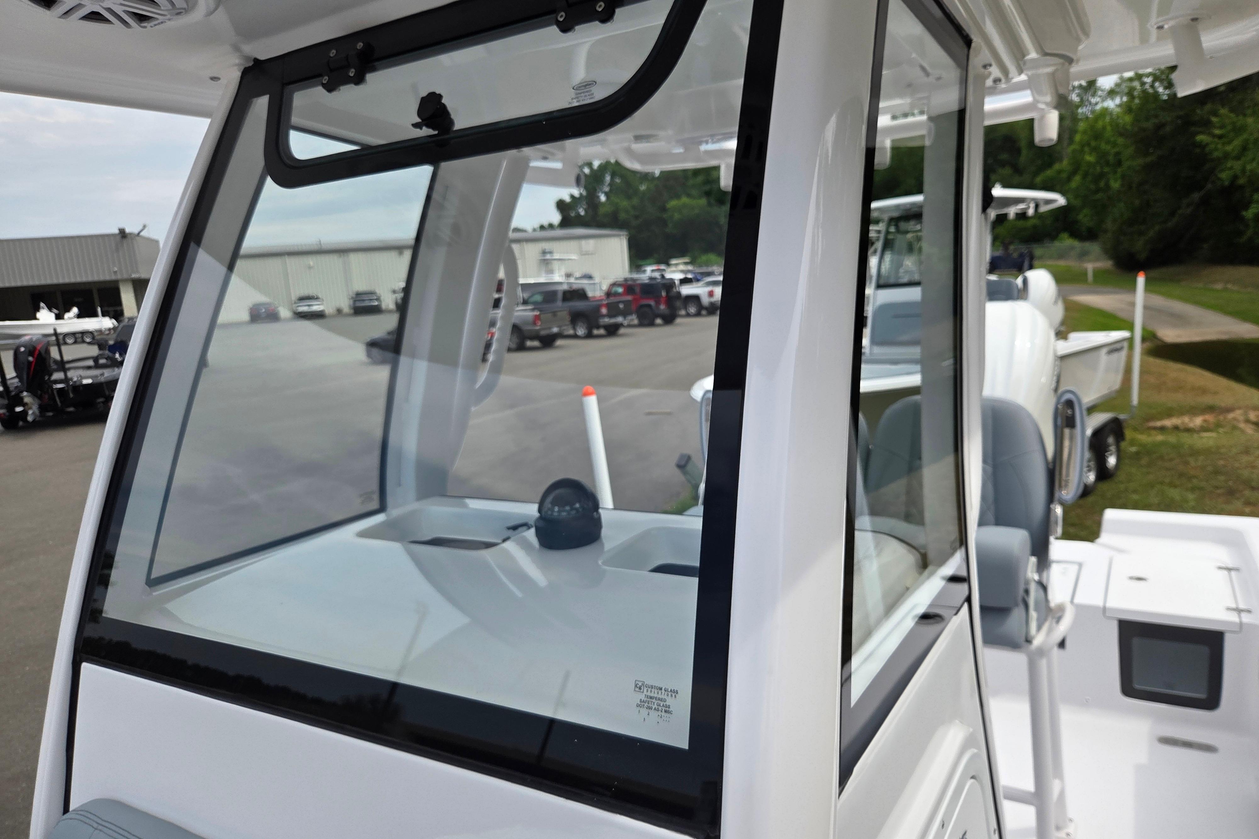 2026 Sportsman Masters 247OE Bay Boat cockpit view with windshield and seating.