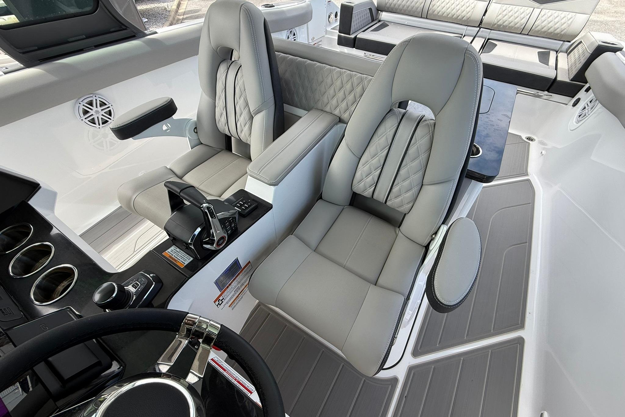 Luxurious interior of 2027 Monterey Elite 30 OB boat with plush seating and modern controls.