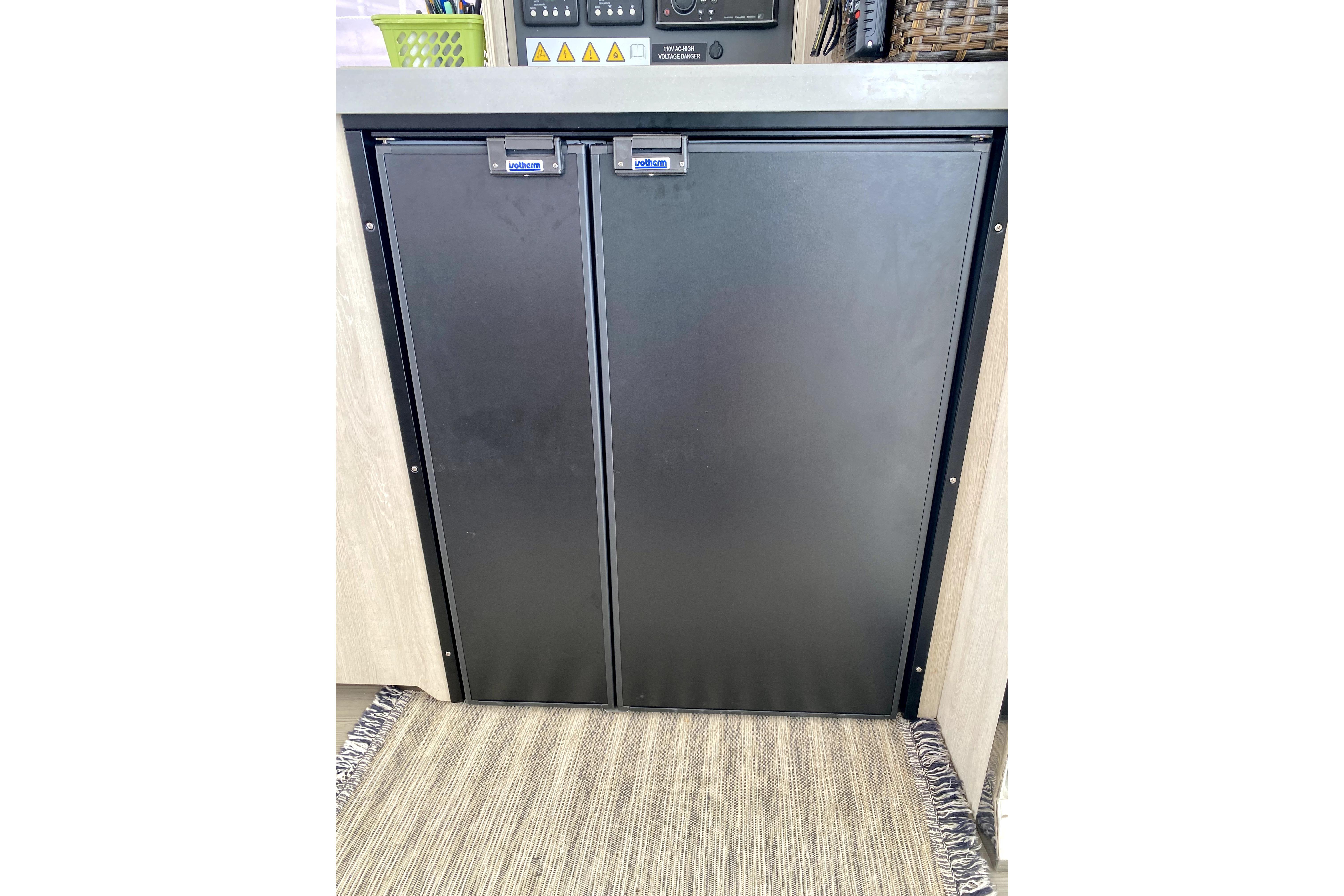 Black double-door refrigerator in a 2017 Leopard 40 catamaran interior.
