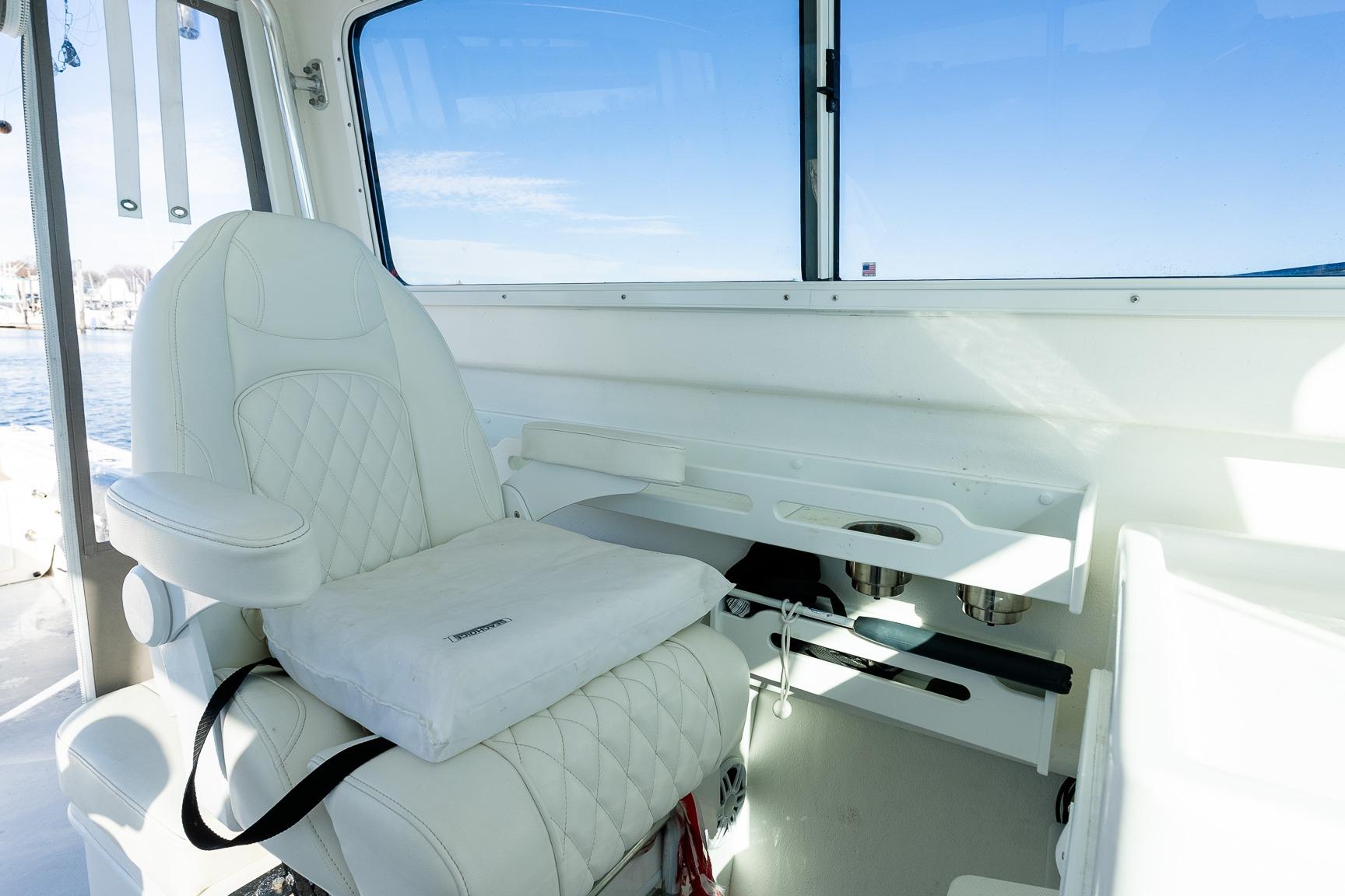 Luxurious interior of 2024 Steiger Craft 31 Fisherman with white seating and ocean view.