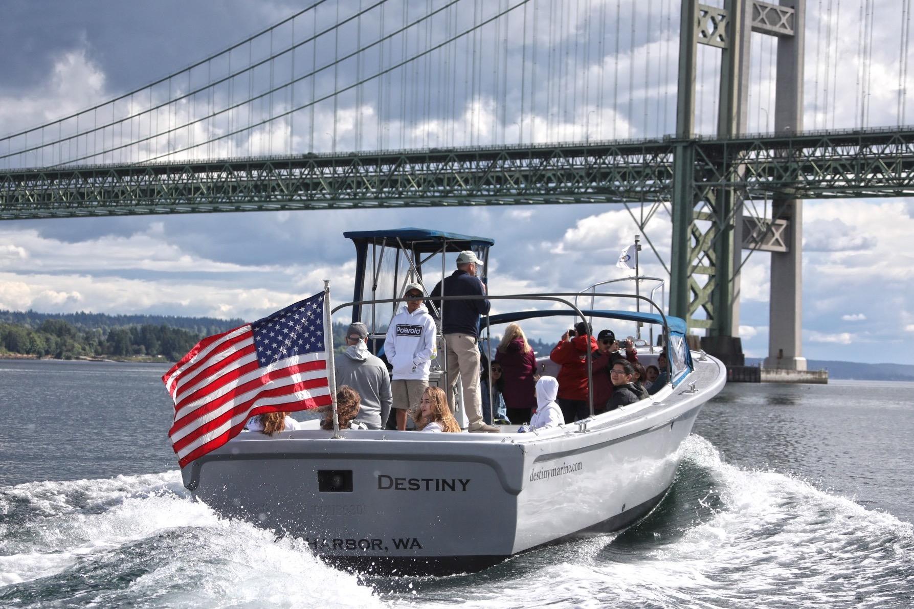 Boat named "Destiny" with American flag under bridge, Navy Lodge, US Navy, 1994.