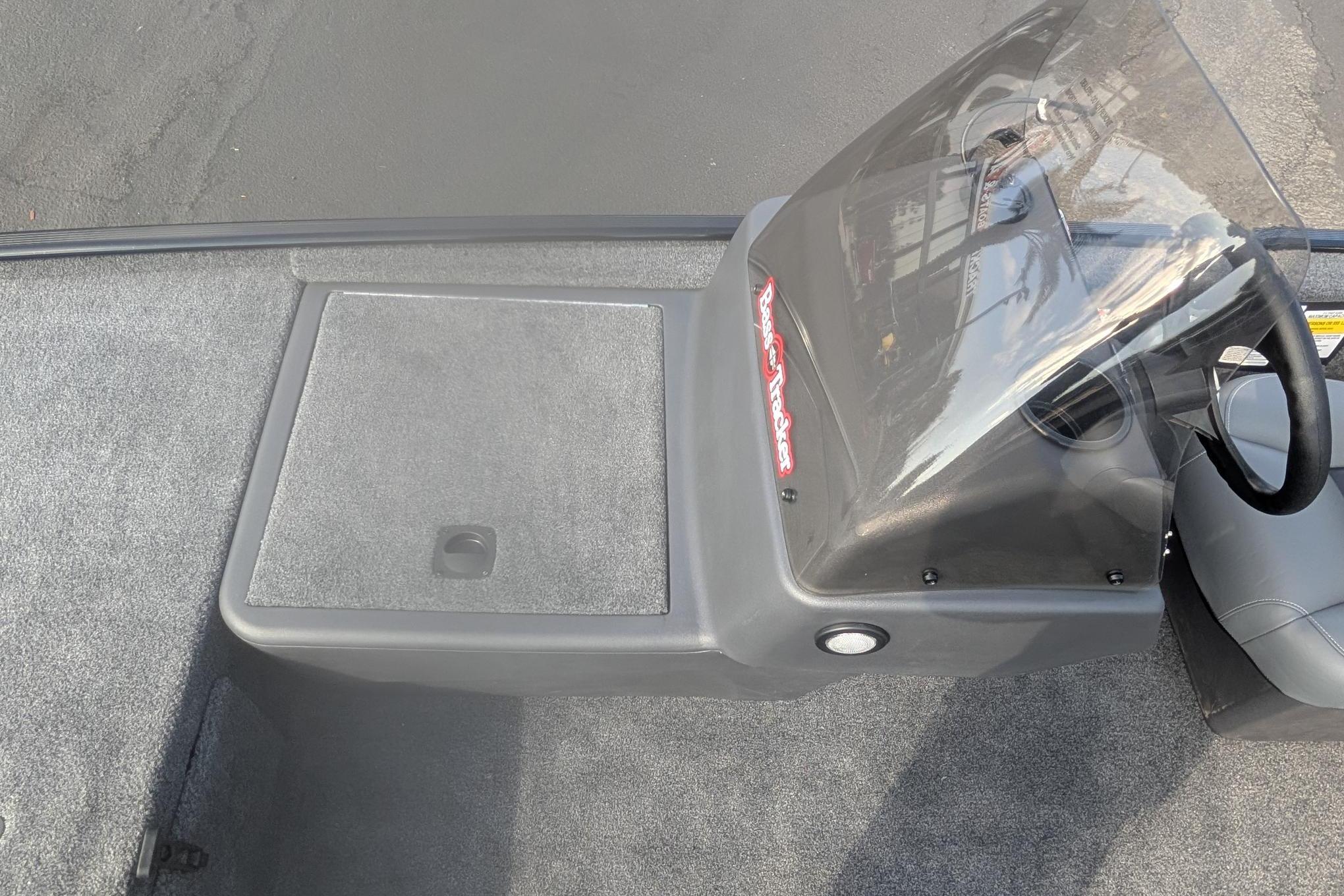 2026 Tracker Bass Tracker Classic XL boat console with windshield and storage compartment.