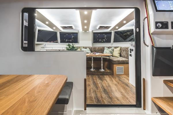 Modern Vision 444 yacht interior, featuring sleek design, wood flooring, and comfortable seating, 2026 model.