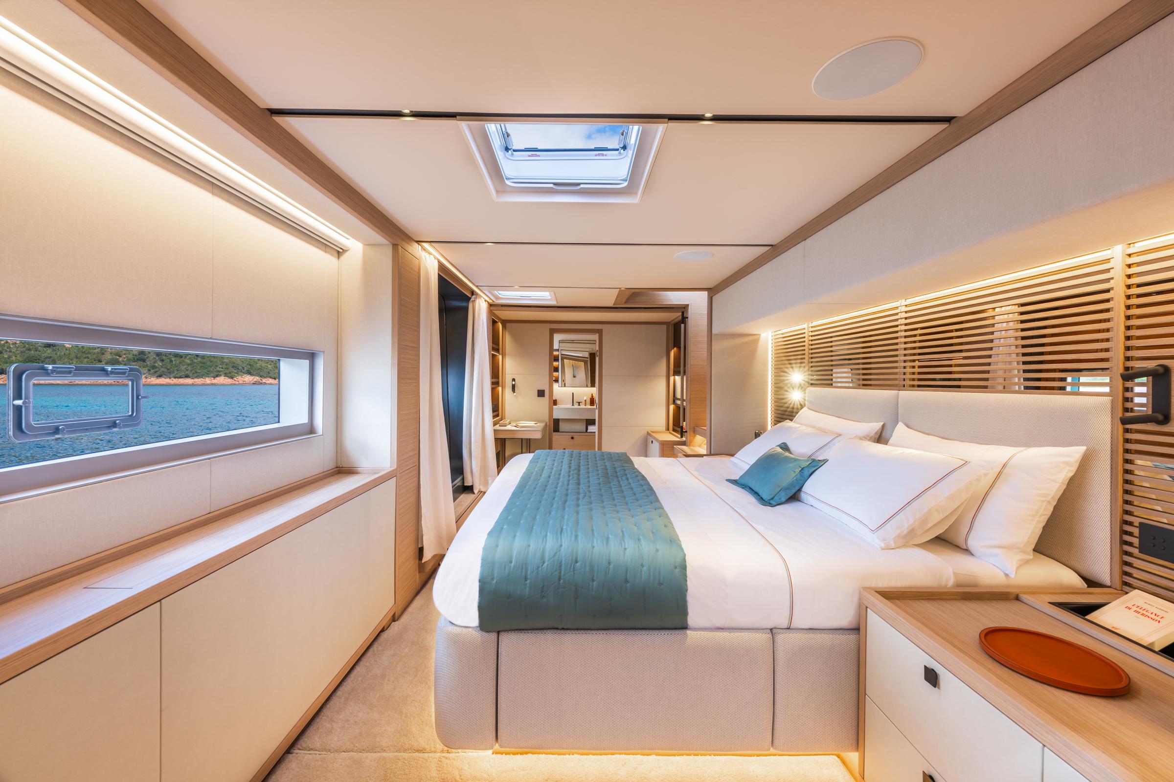 Luxurious 2025 Lagoon Eighty 2 yacht bedroom with elegant decor and ocean view.