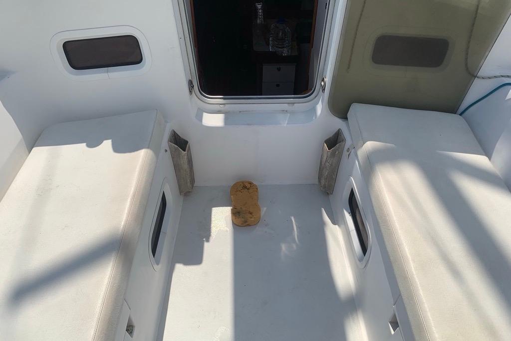 Interior view of a 2004 J Boat J/133, featuring seating and a sponge on the floor.