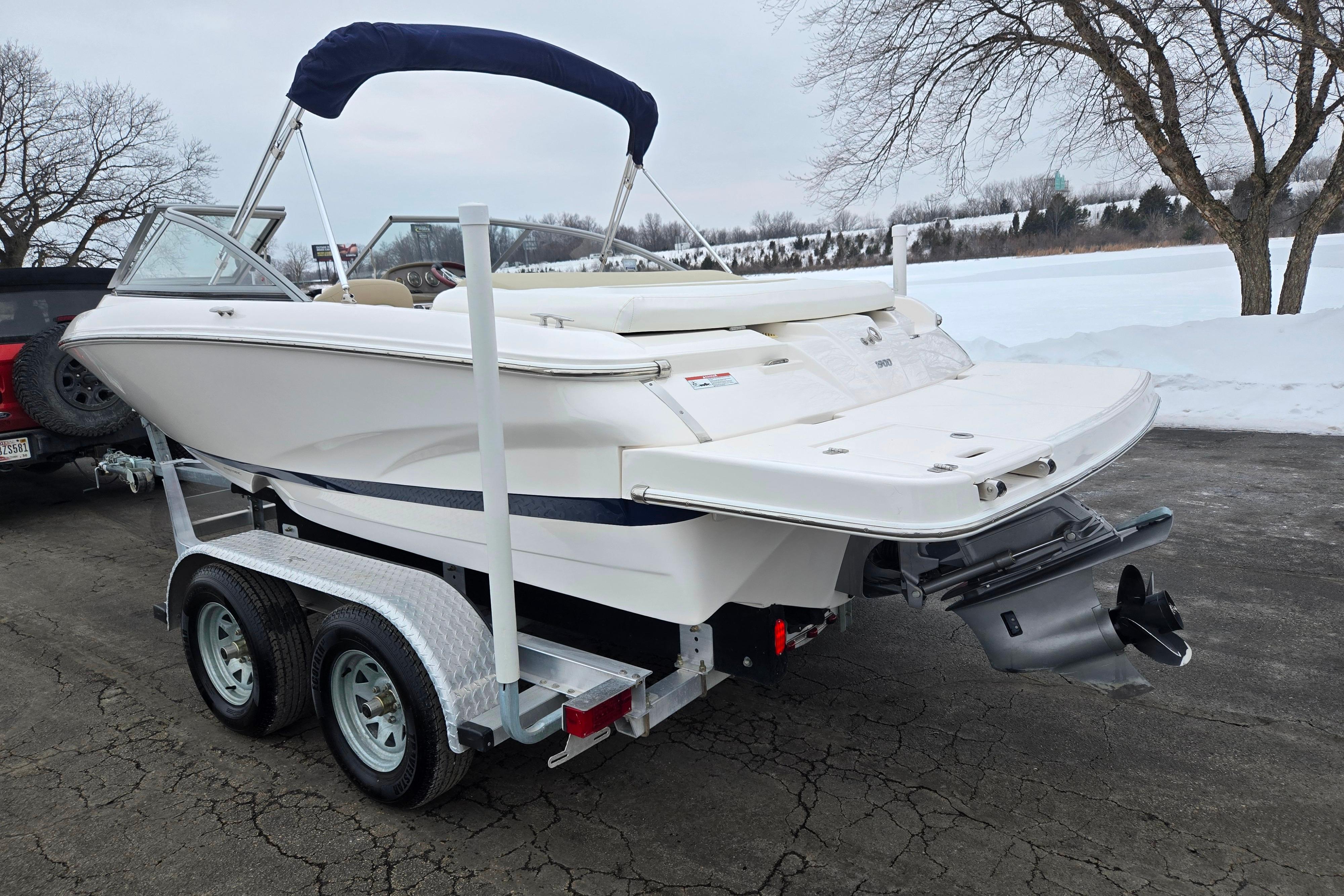 2015 Regal 1900 ES Bowrider on trailer, parked on snowy pavement.