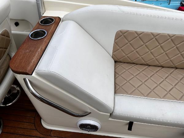2014 Chris-Craft 28 LAUNCH boat interior with tan diamond-stitched seats and cup holders.
