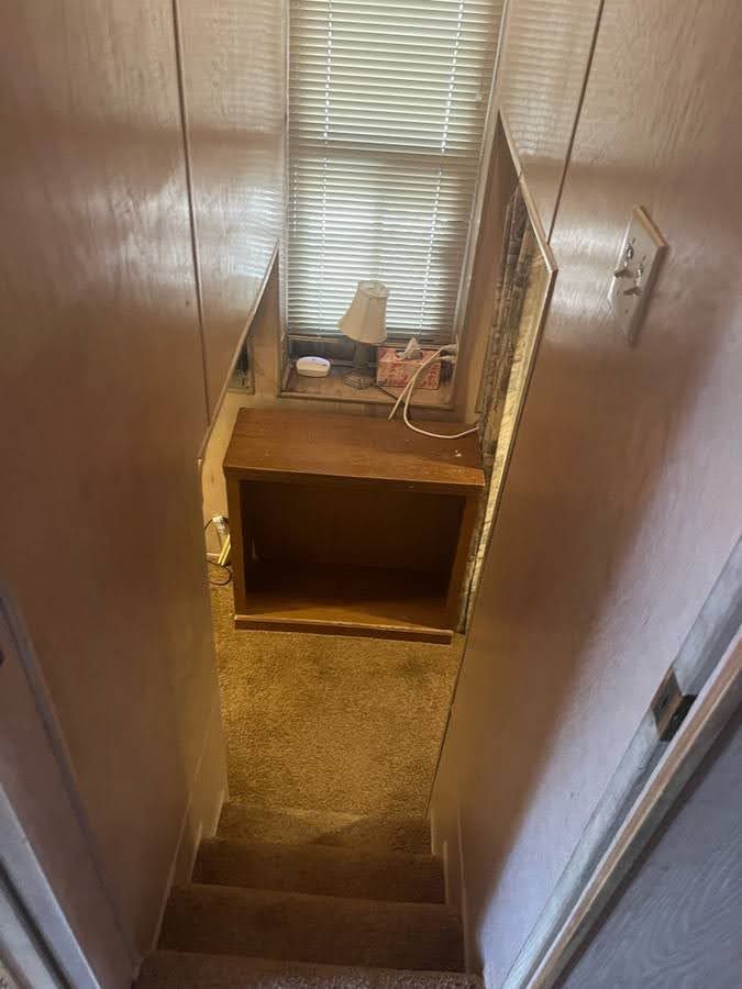 Interior of a 1993 Lakeview houseboat with stairs and window.
