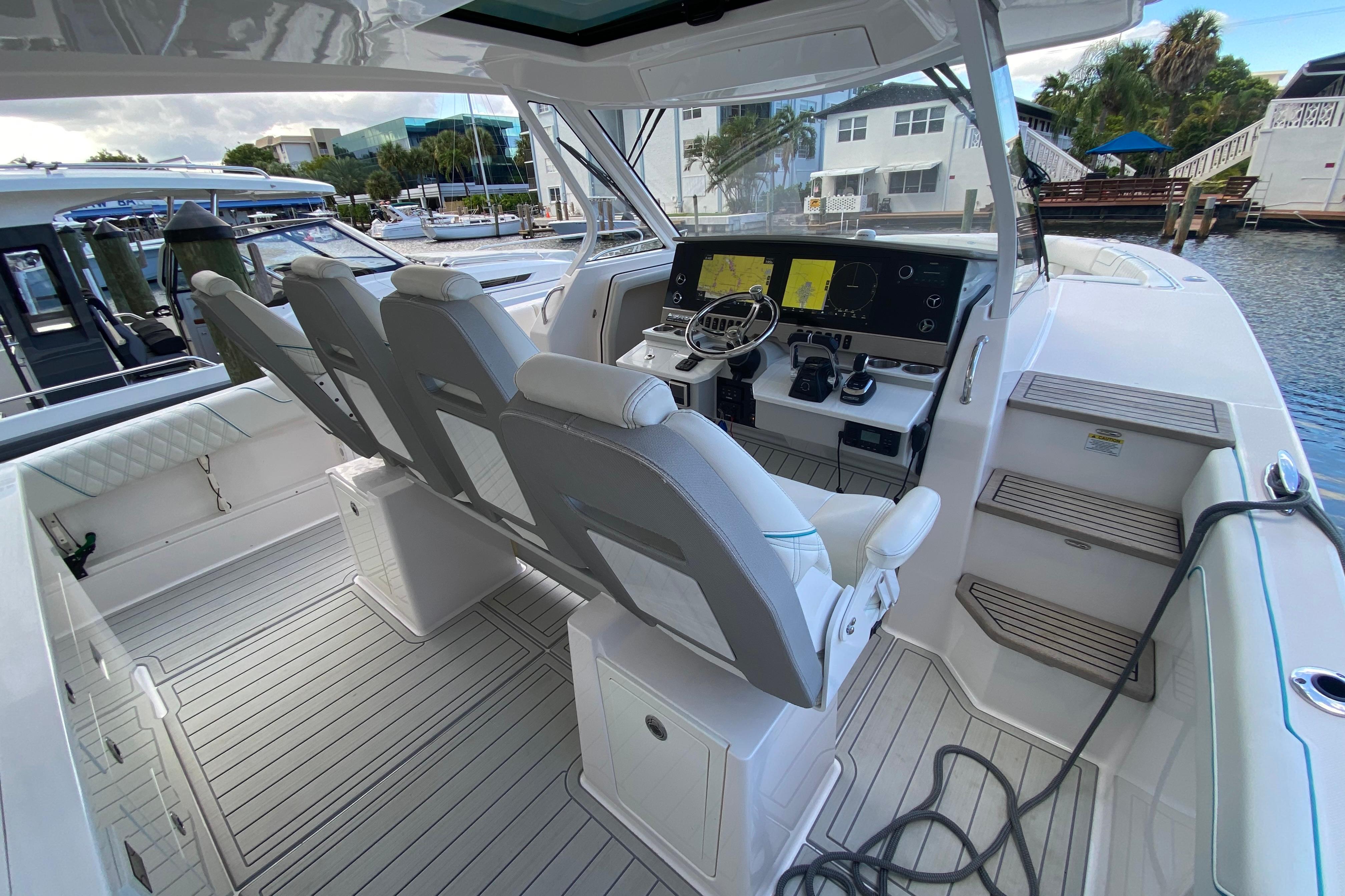 2021 Regal 38 SAV boat interior with modern helm and seating, docked at marina.