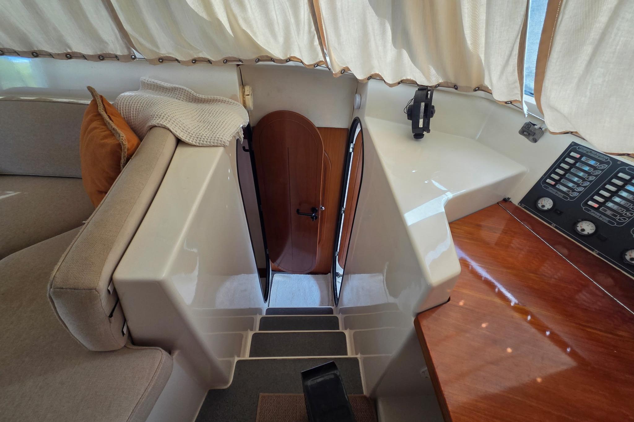 Interior of 2000 Fountaine Pajot Maryland 37 yacht with seating and control panel.