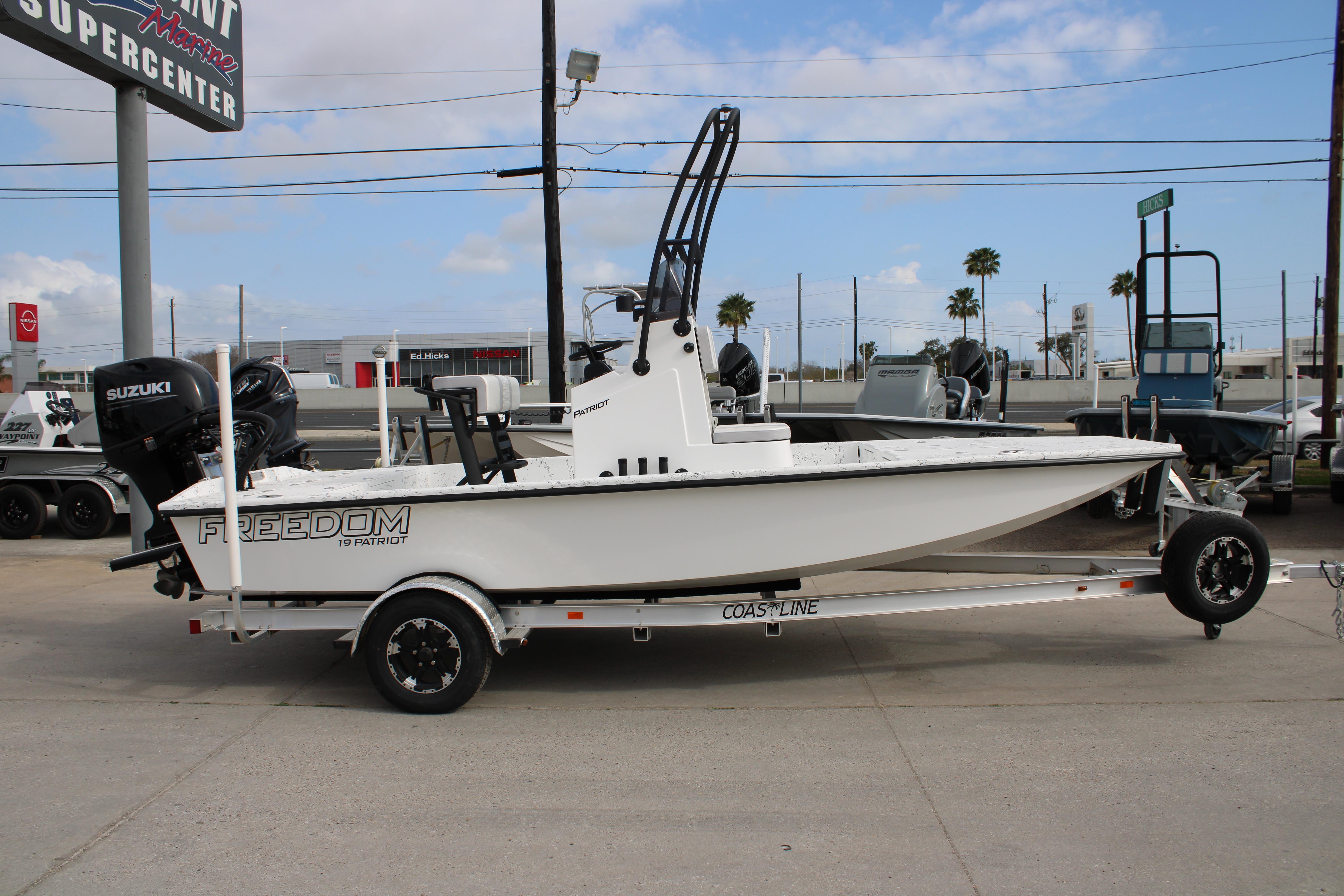 2026 Freedom Boats 19 PATRIOT on trailer at a marine supercenter.