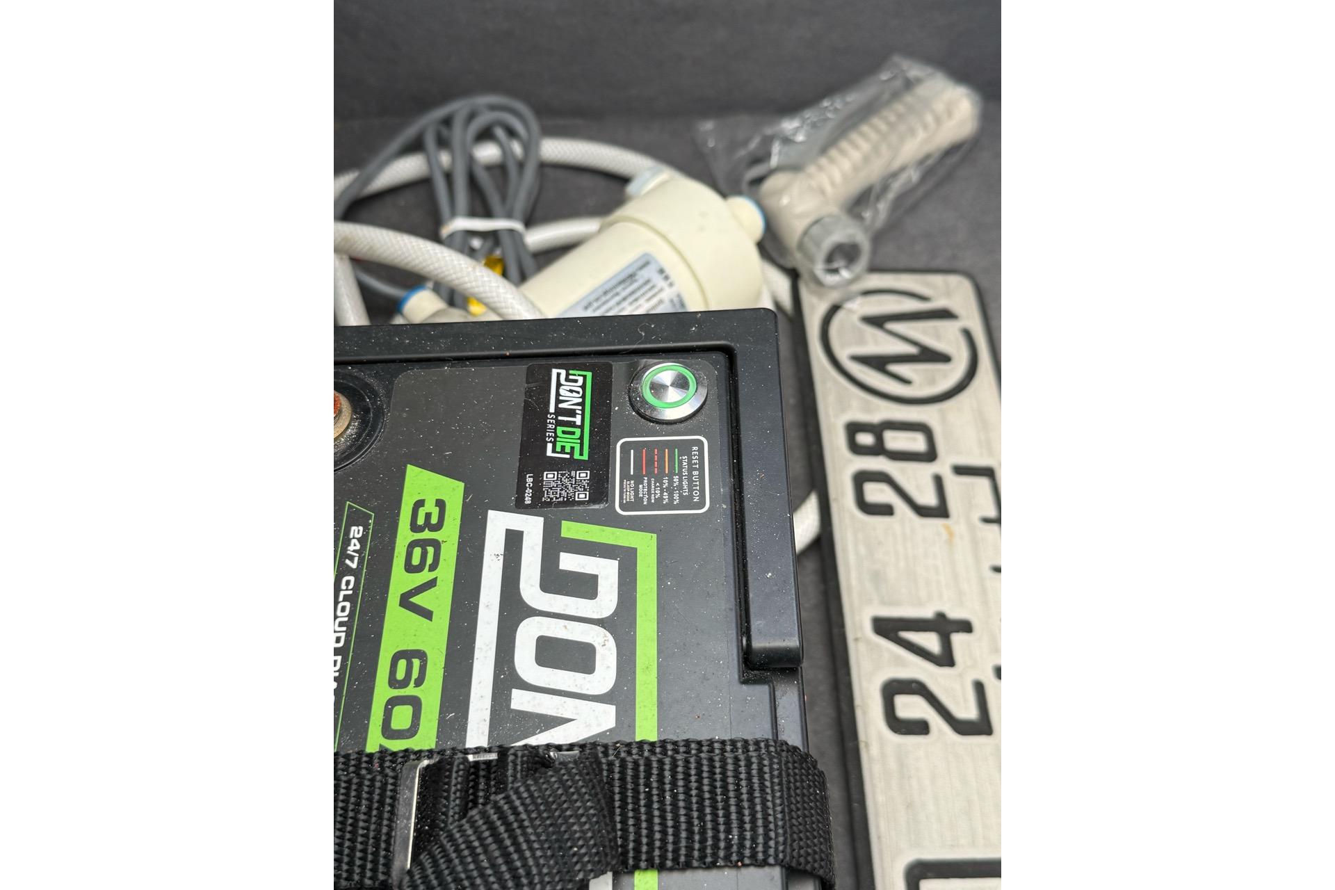 Battery and cables in a 2021 Custom Infusion 34 CC boat compartment.