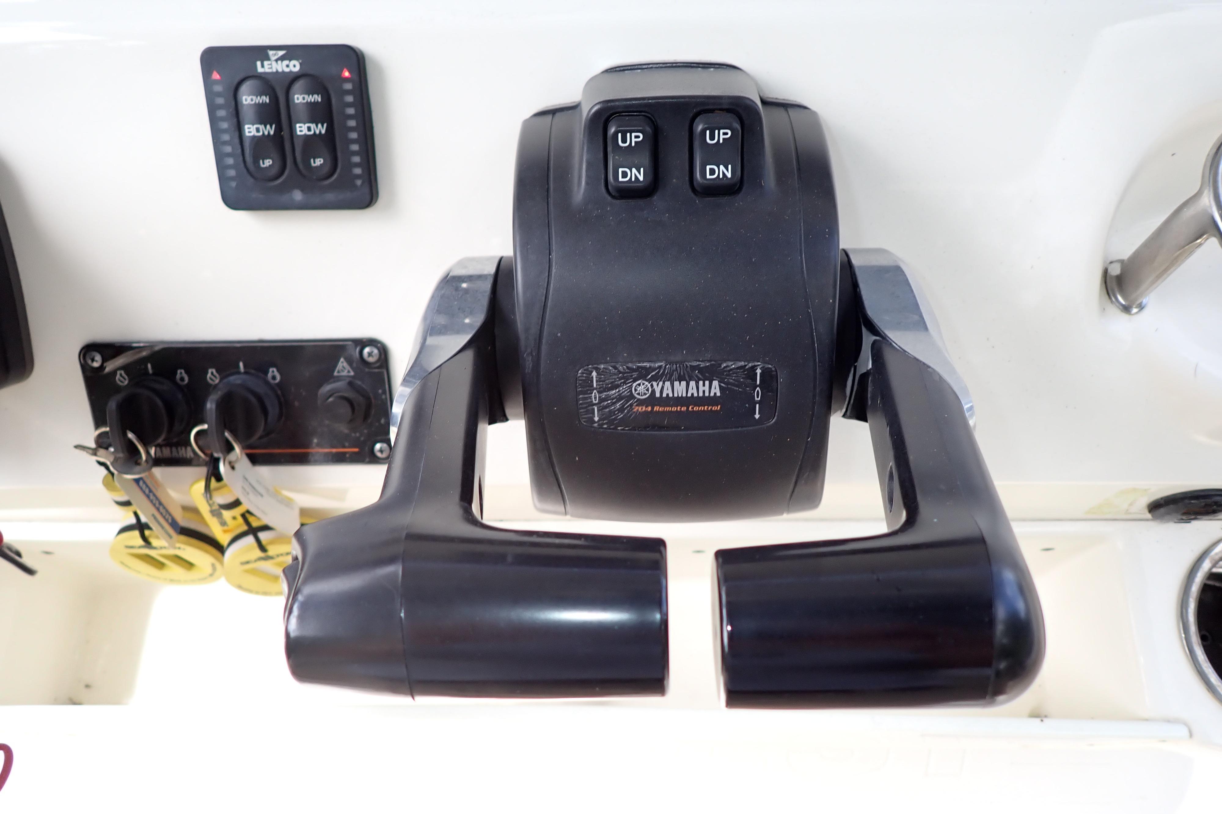 Yamaha throttle control on 2019 Key West 263 FS boat dashboard with Lenco trim tab switches.