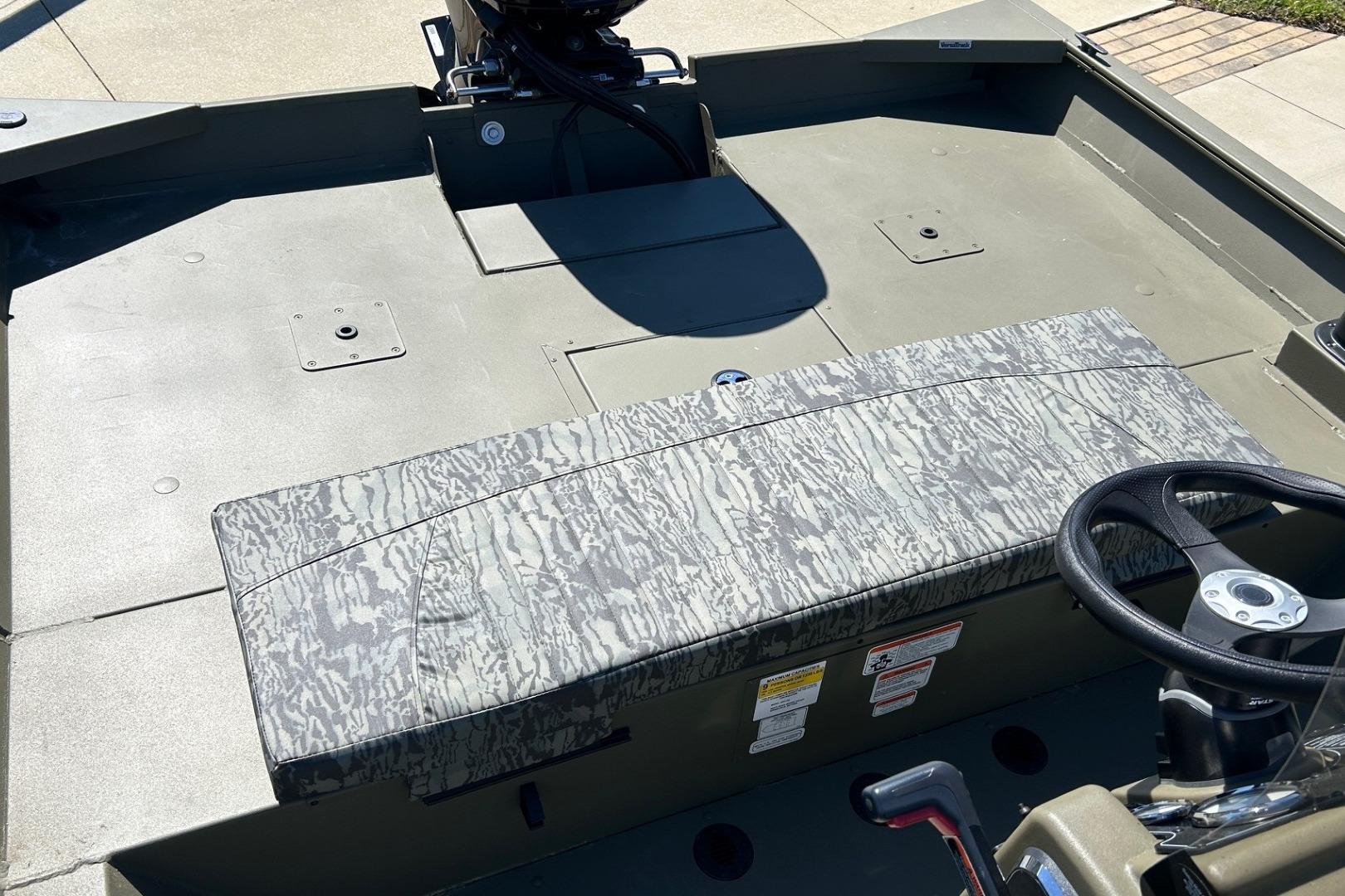 2026 Tracker Grizzly 2072 CC boat interior with camouflage seating and steering wheel.