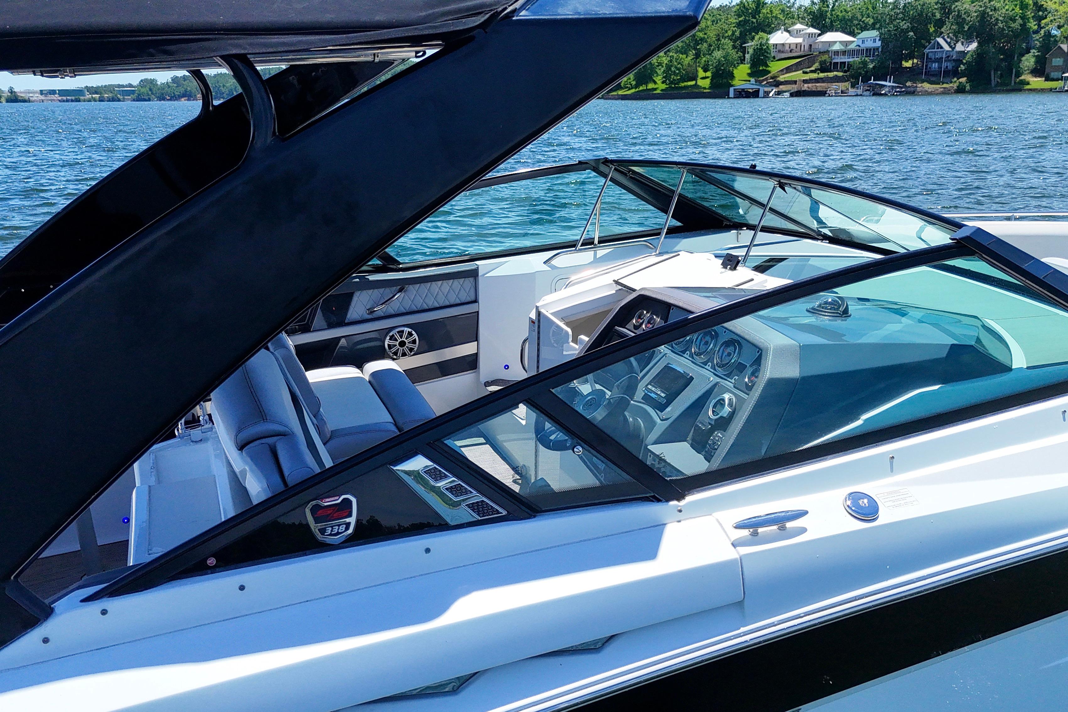 2017 Cruisers Yachts 338 Bow Rider on a scenic lake, showcasing sleek design and luxury features.