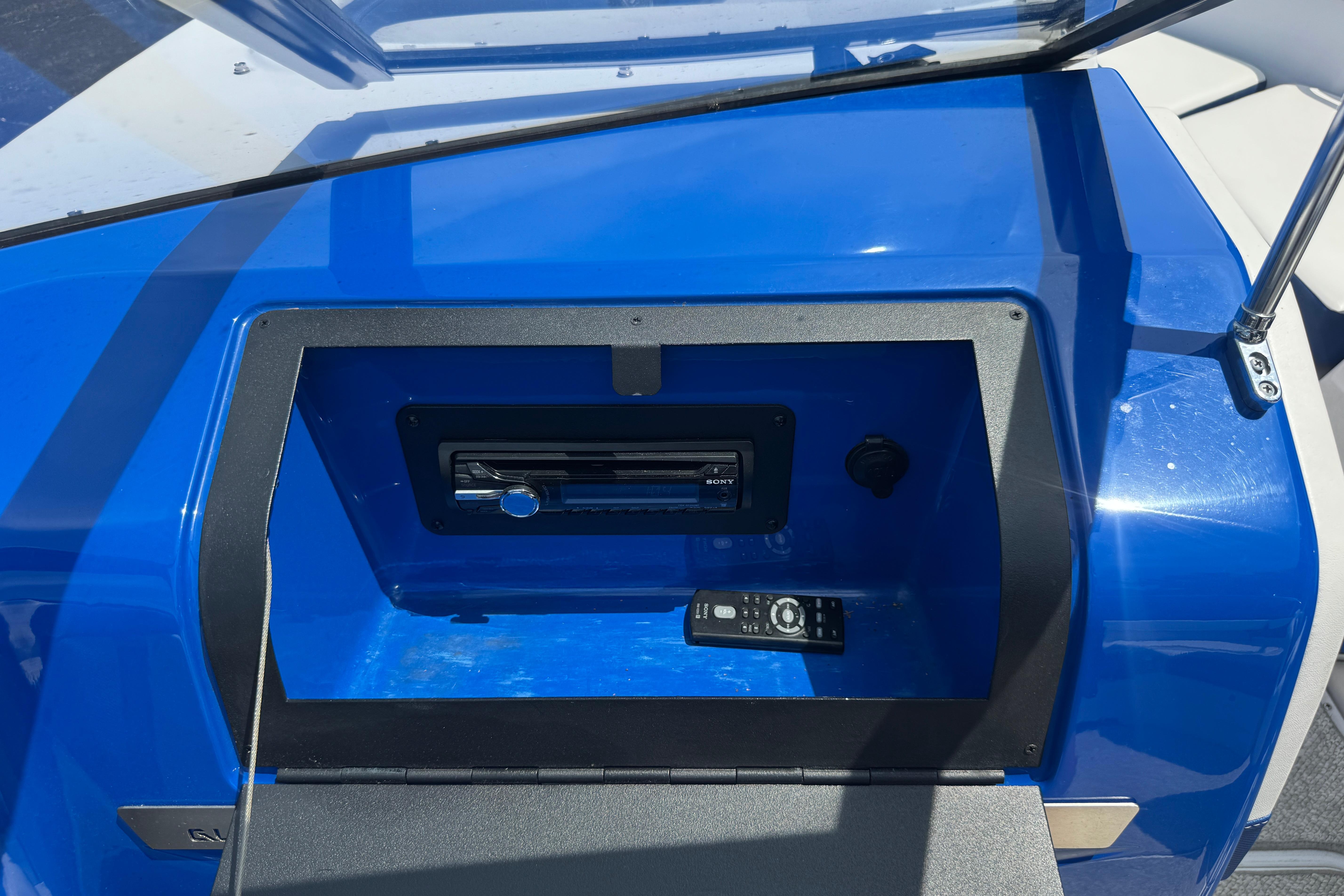 2013 Glastron GT 225 boat dashboard with stereo system and remote control.