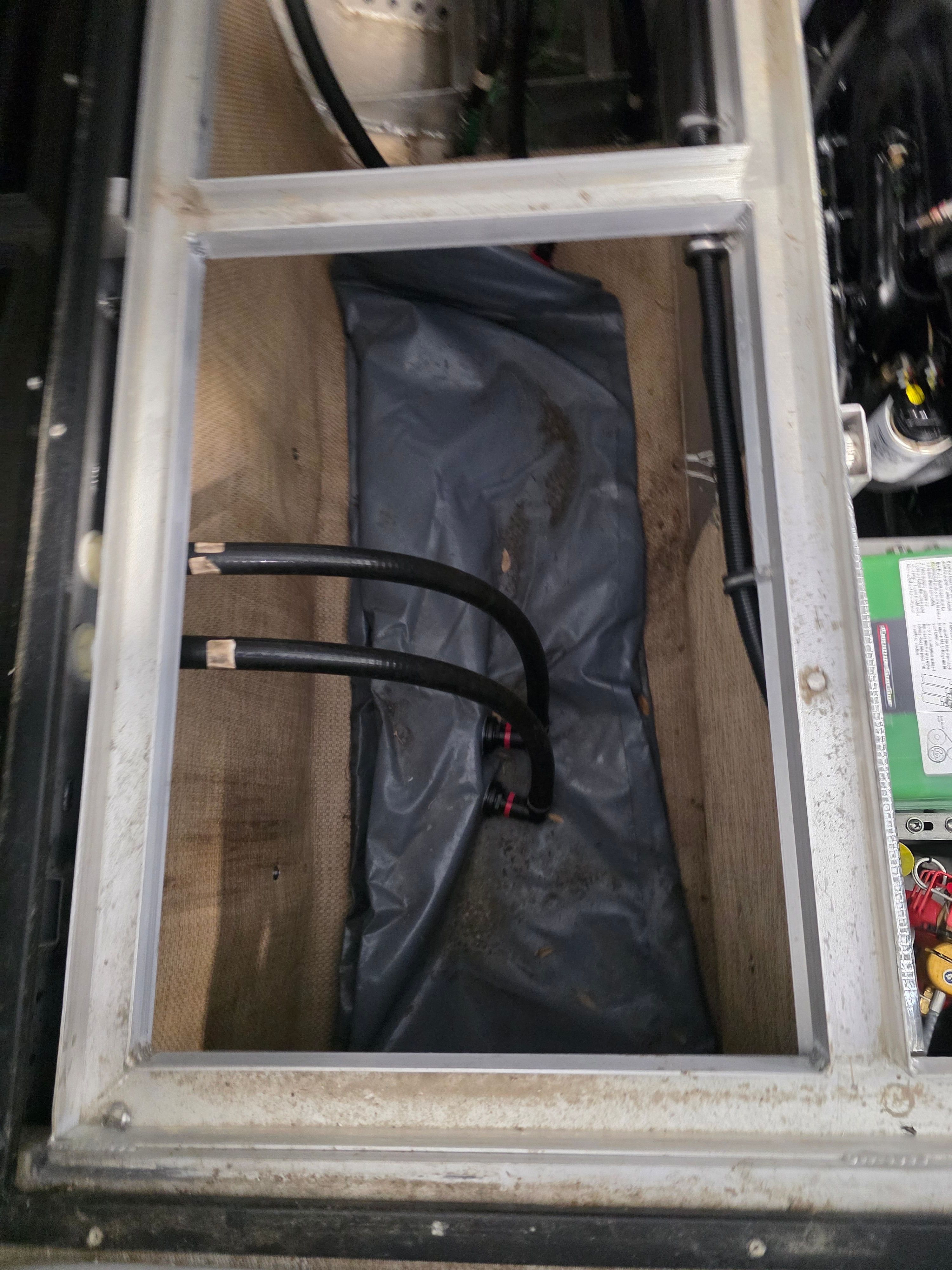 Interior view of 2021 Montara SURF BOSS 25 with hoses and battery.