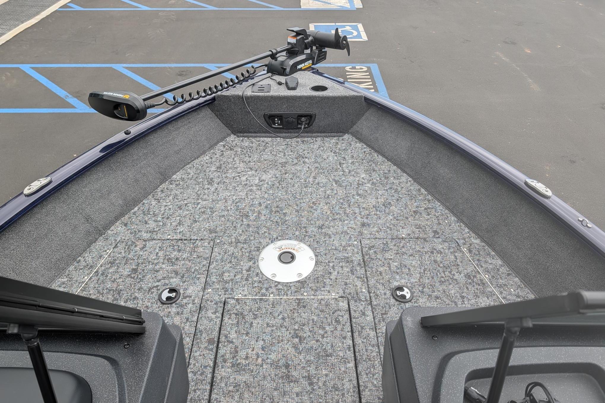 2026 Tracker Pro Guide V-175 WT boat deck with trolling motor in parking lot.