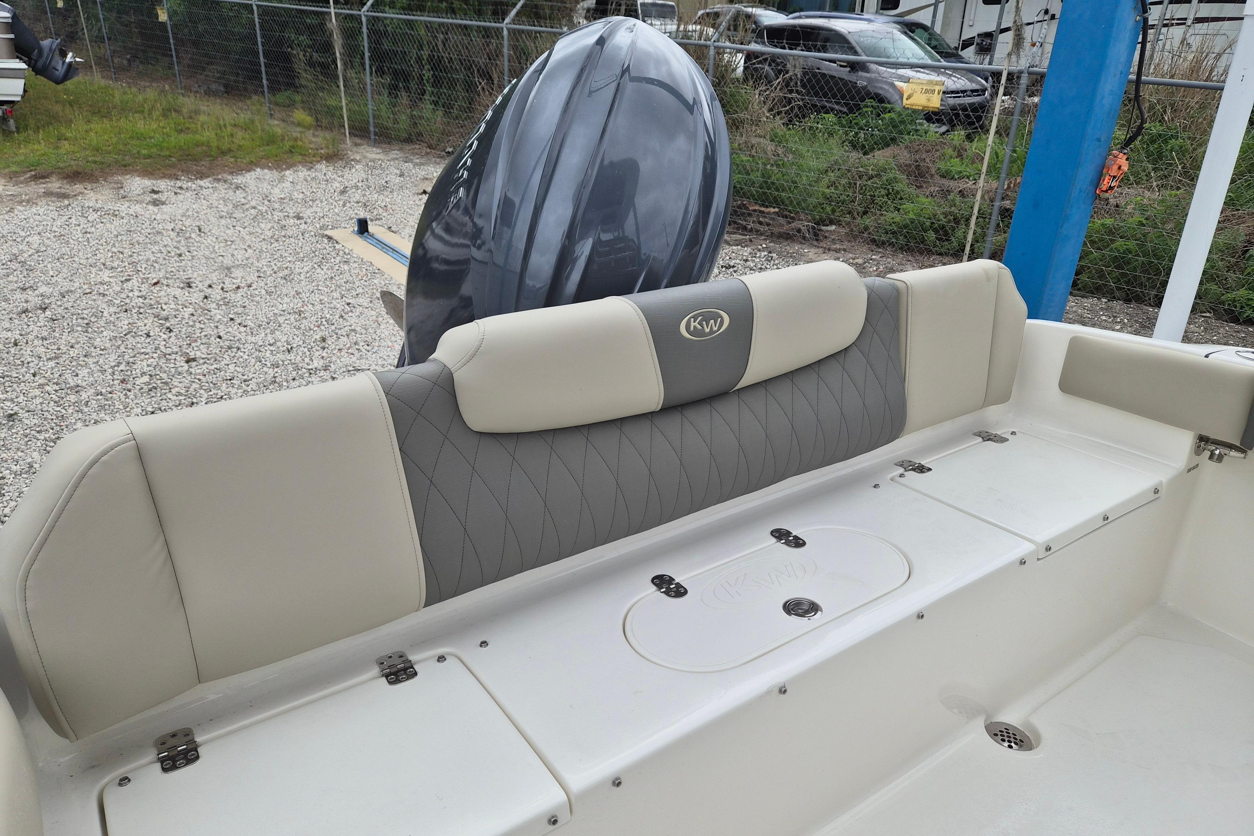 2026 Key West 219 FS boat interior with cushioned seating and storage compartments.