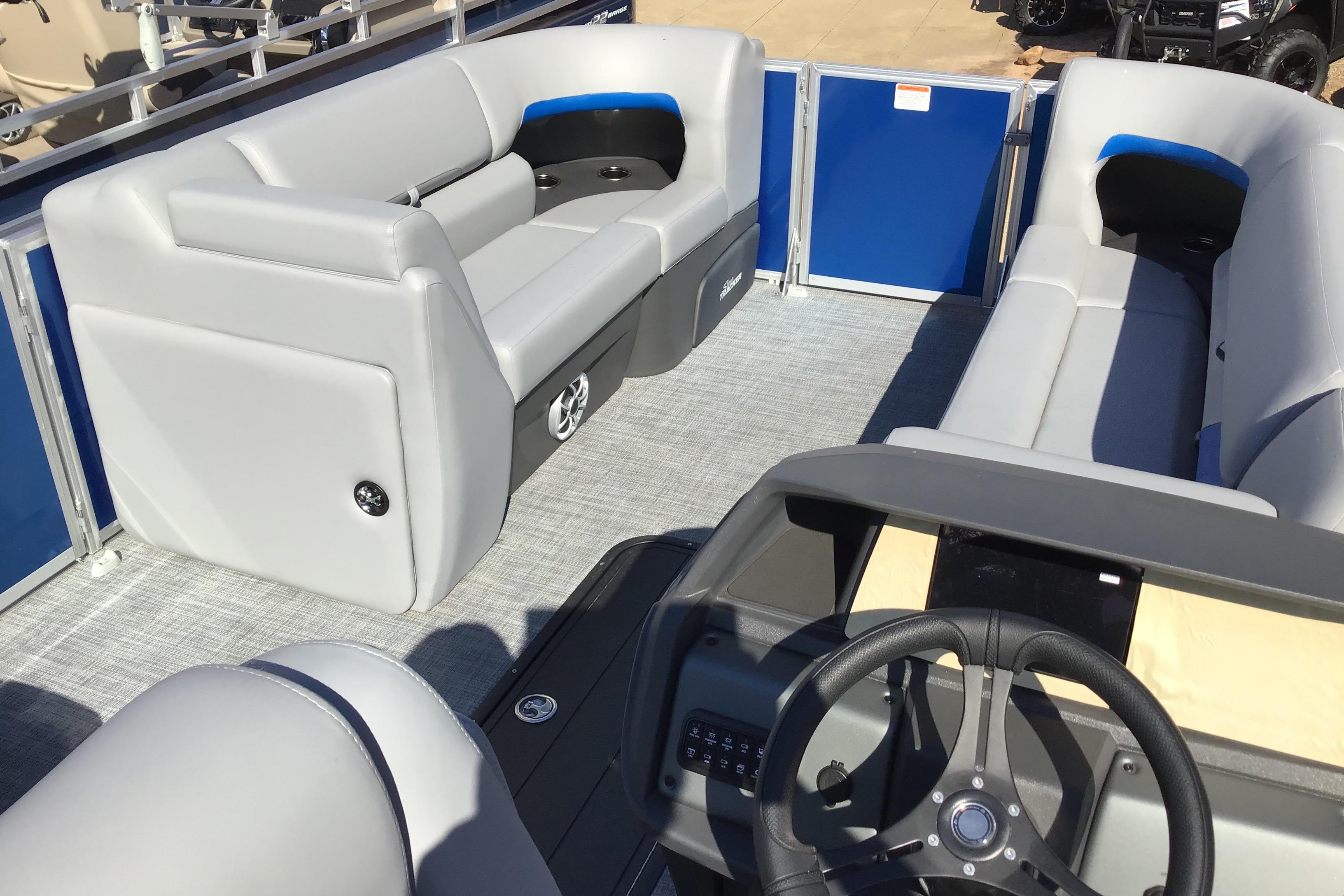 2026 Sun Tracker Party Barge 22 XP3 interior with gray seating and steering wheel.