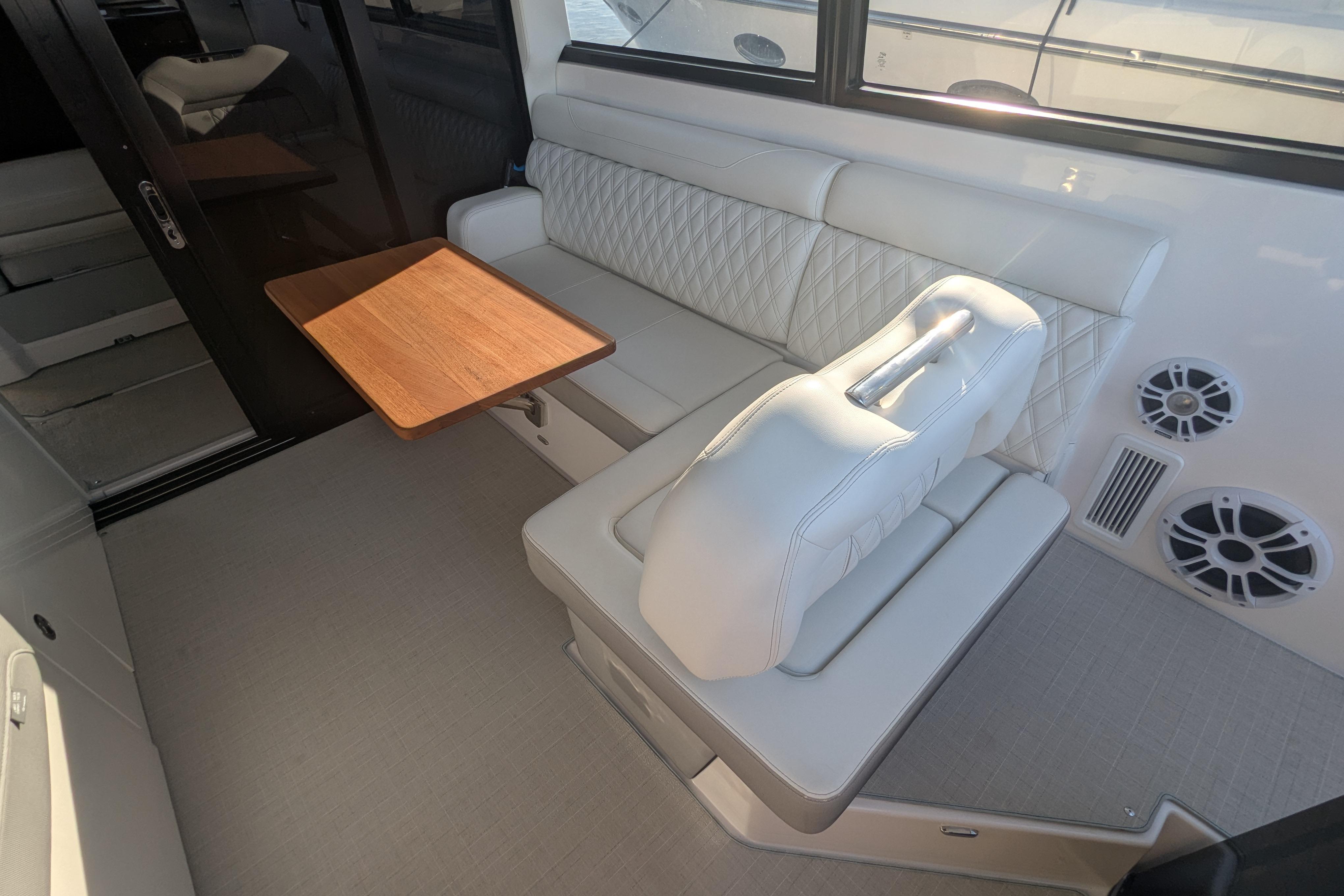 Luxurious interior of 2021 Regal 36 Grande Coupe with elegant seating and wooden table.