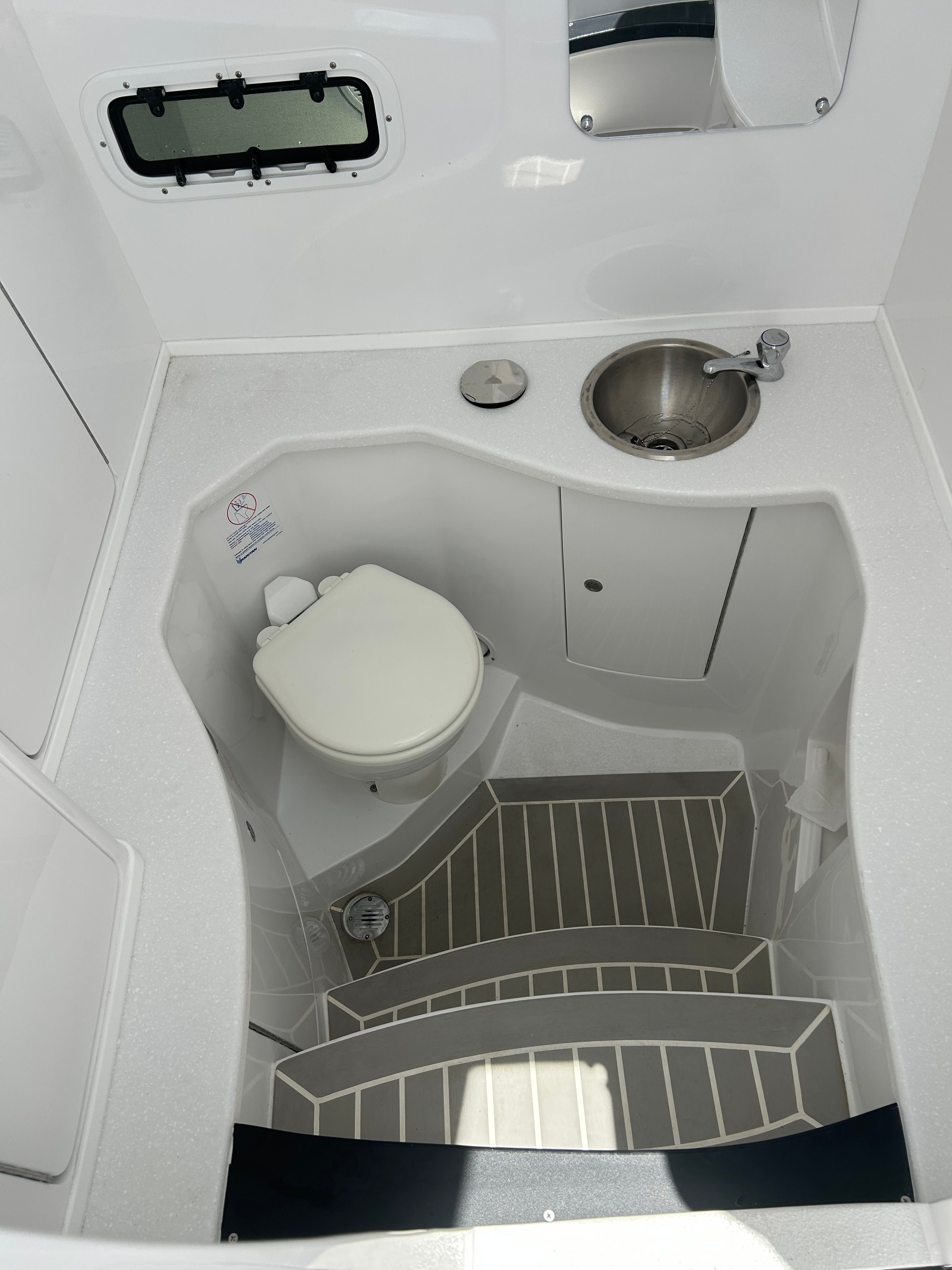 Intrepid 375 Nomad SE 2025 boat cabin with toilet and sink.